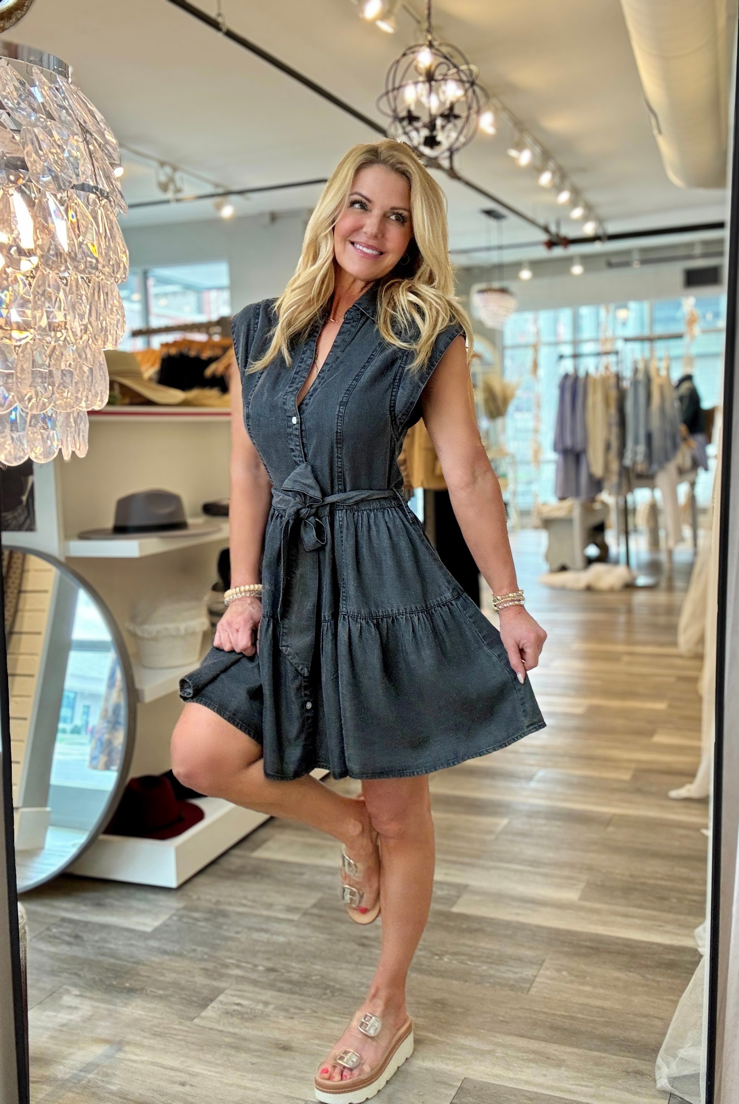 Black washed denim dress with tie waist in Mainstream Boutique Bloomington wearing with sandals.