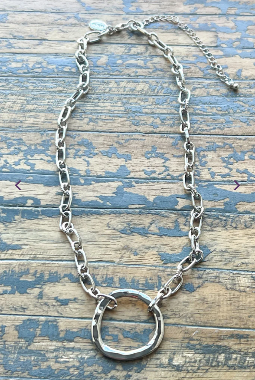 Gretchen necklace is a silver necklace with a silver ring pendant.