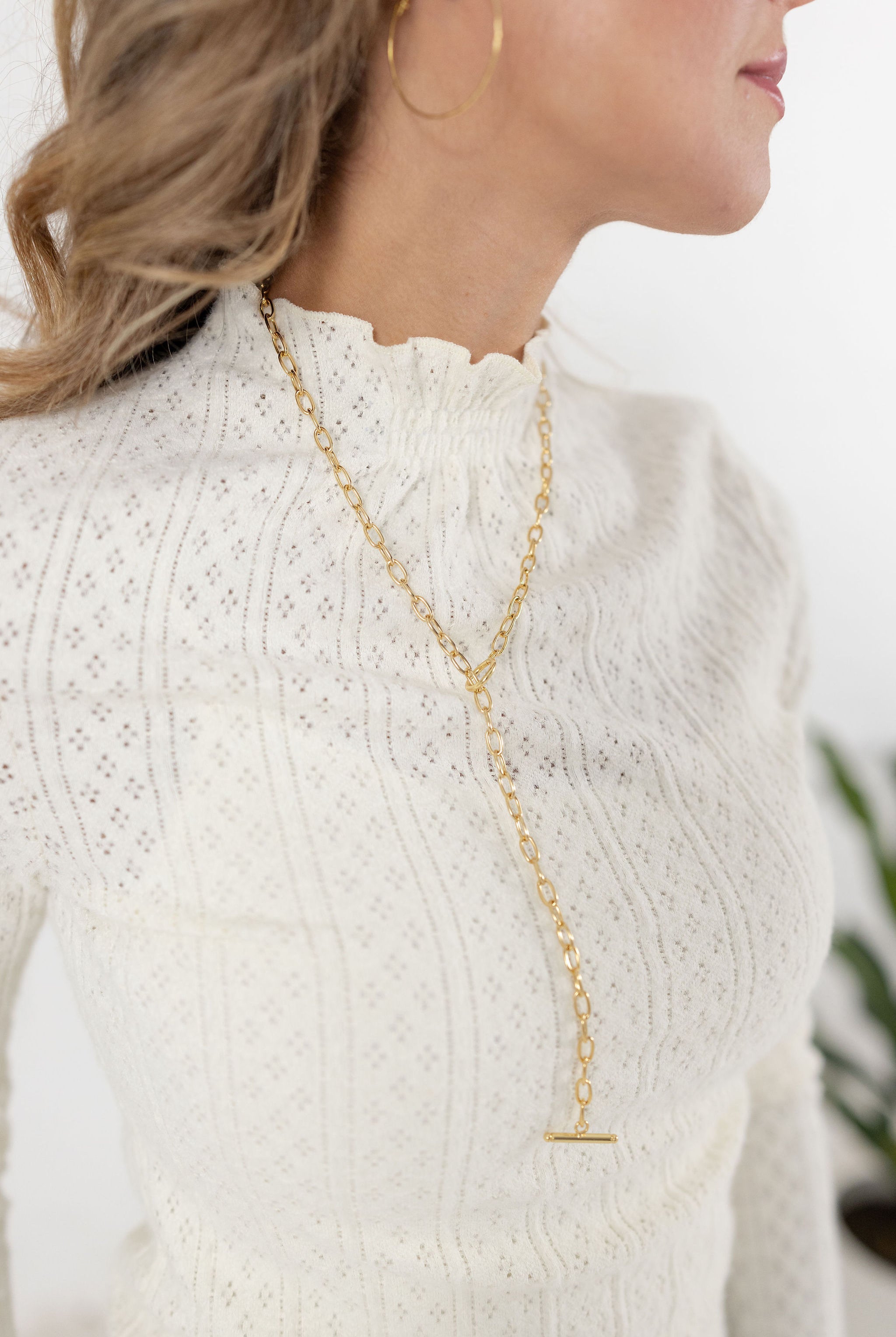close up view of the lettuce edge mock neck top in the color ivory