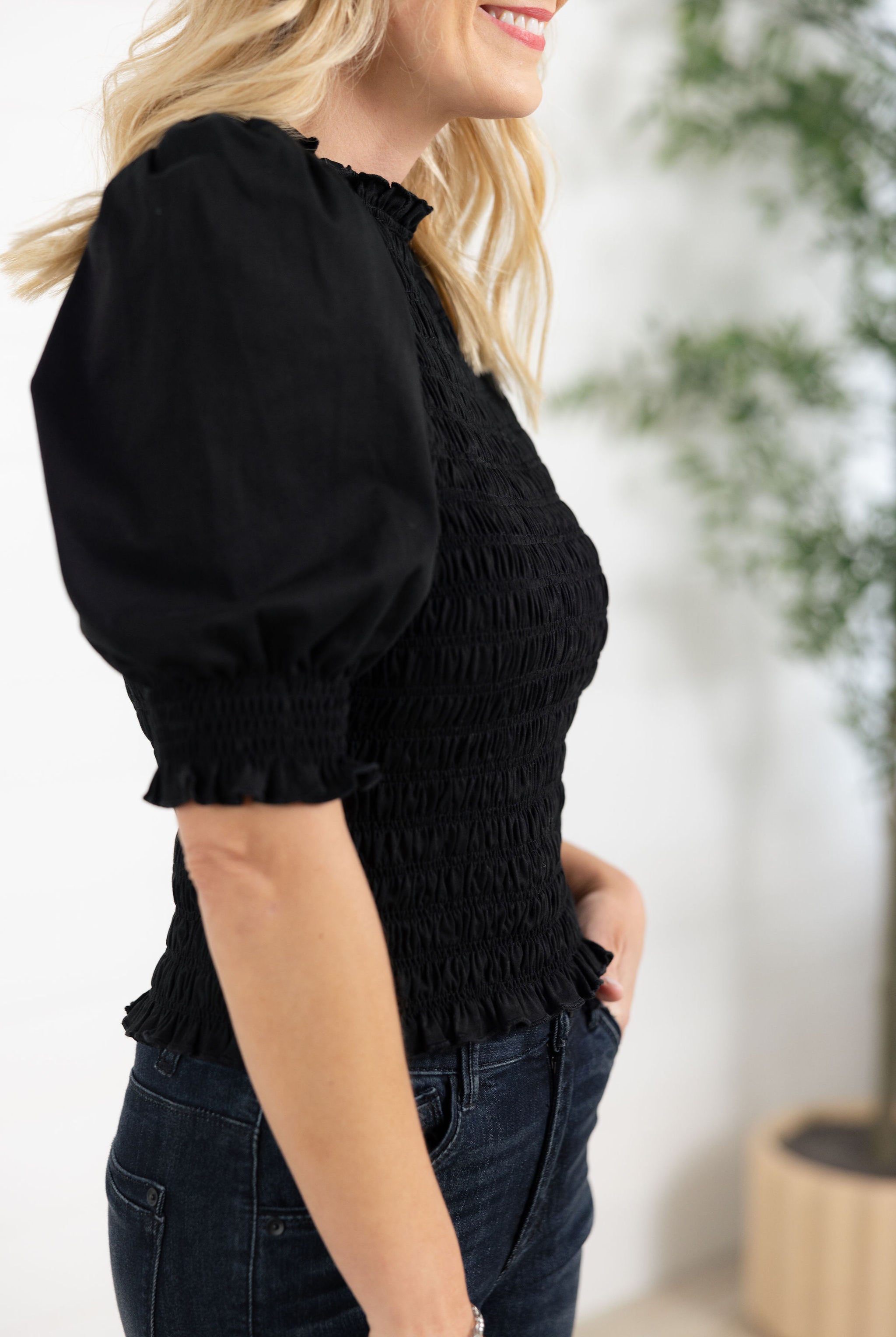 details on arm of Mac and Me black puff sleeve smocked top