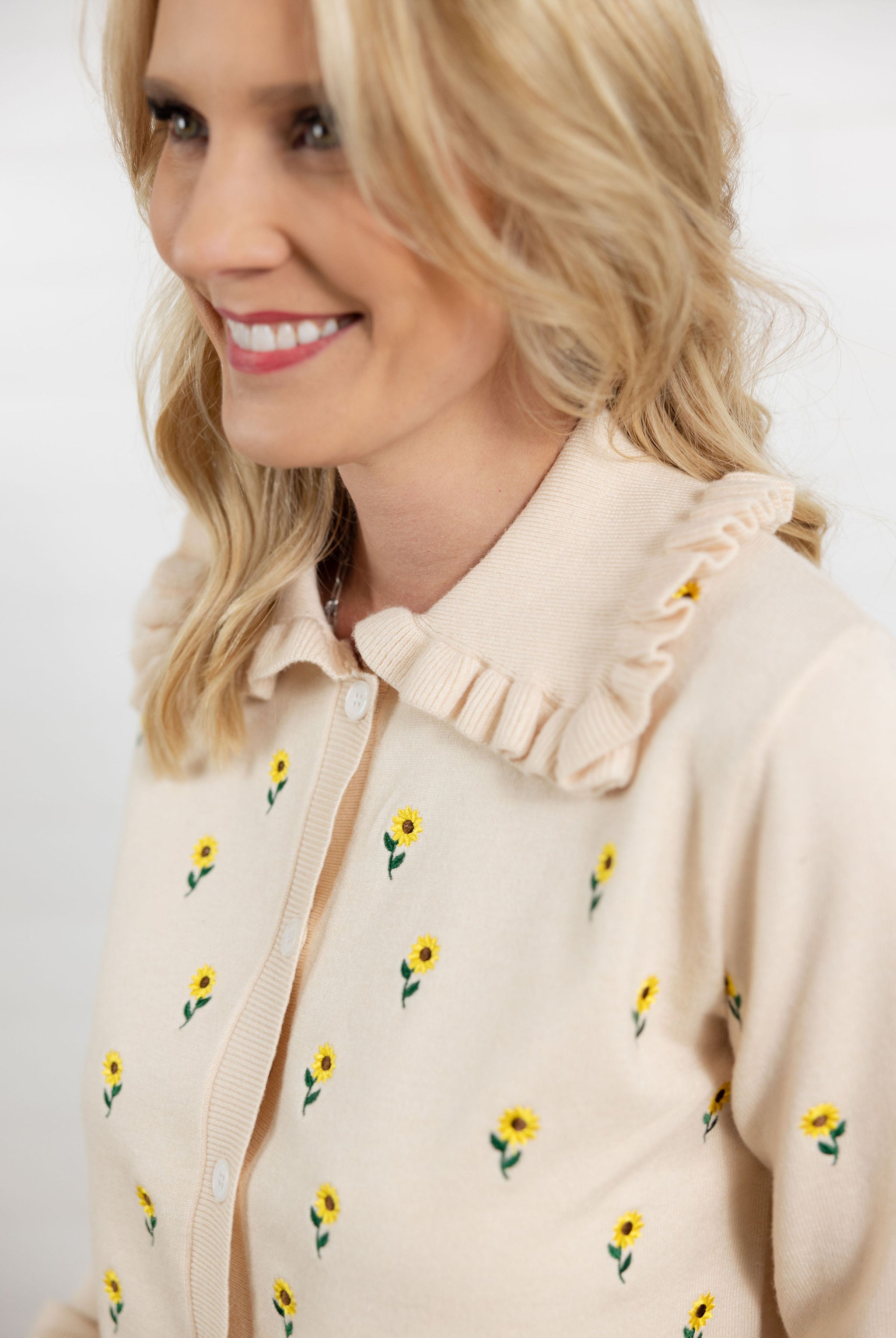 detailed view of Mac and Me cream embroidered sunflower sweater with ruffle collar