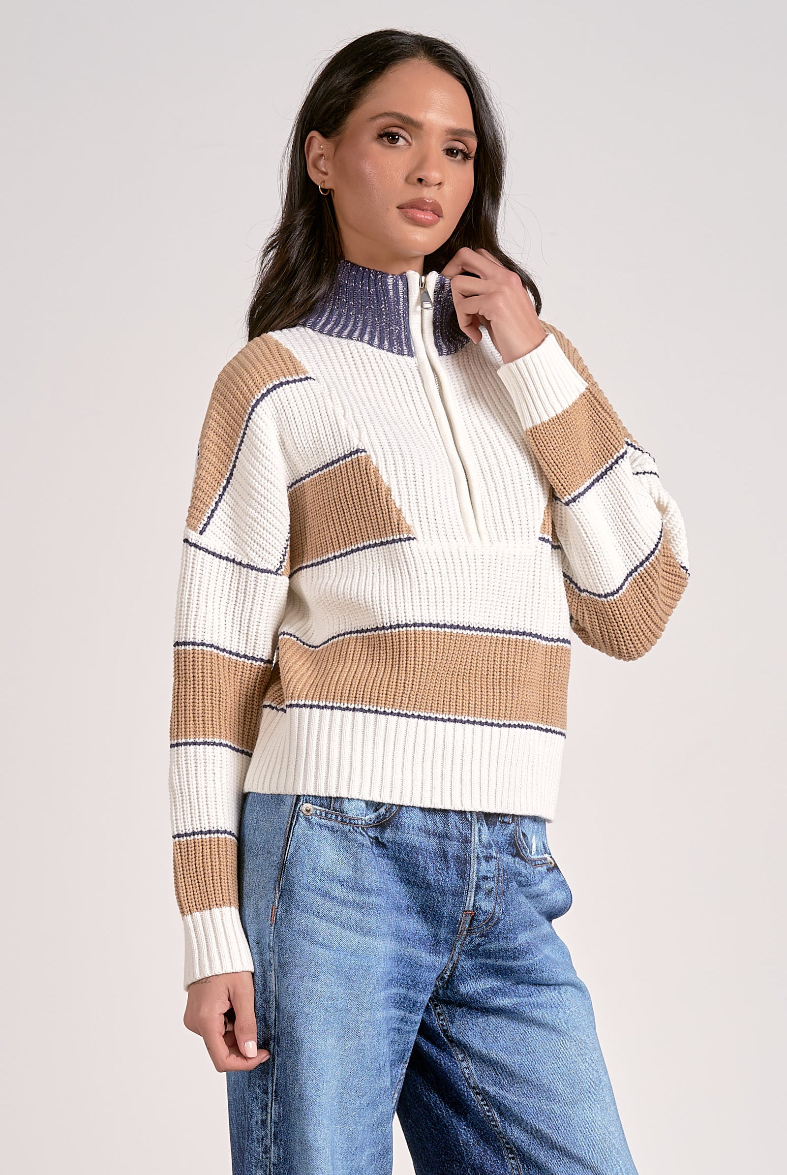 Woman in striped half zip sweater in camel white and blue with fold-down collar