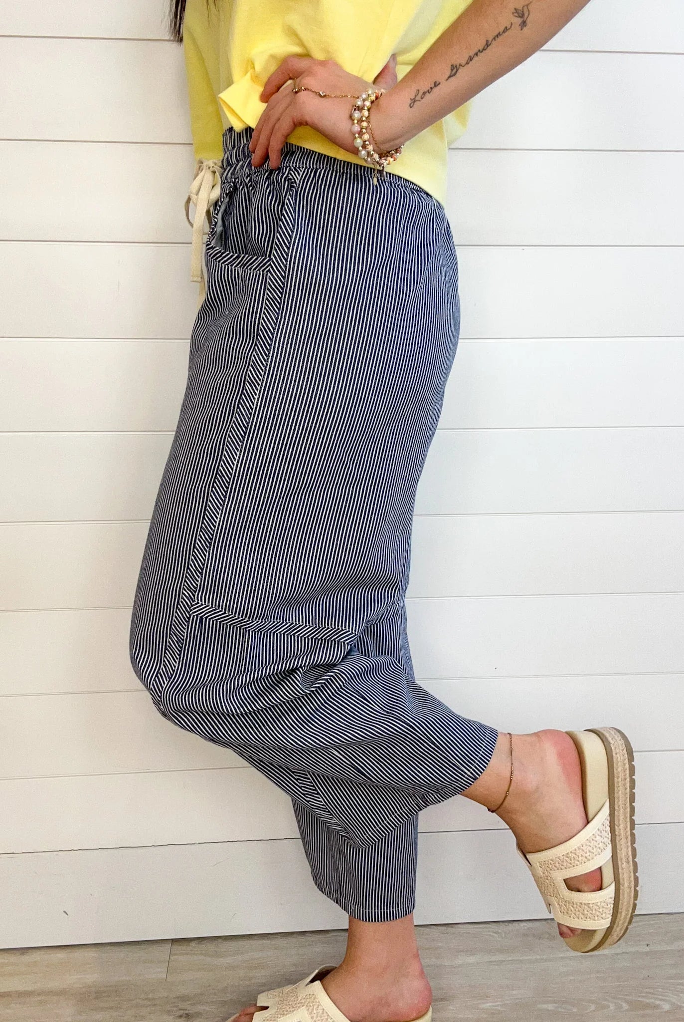 navy striped relaxed fit pants side and close up view