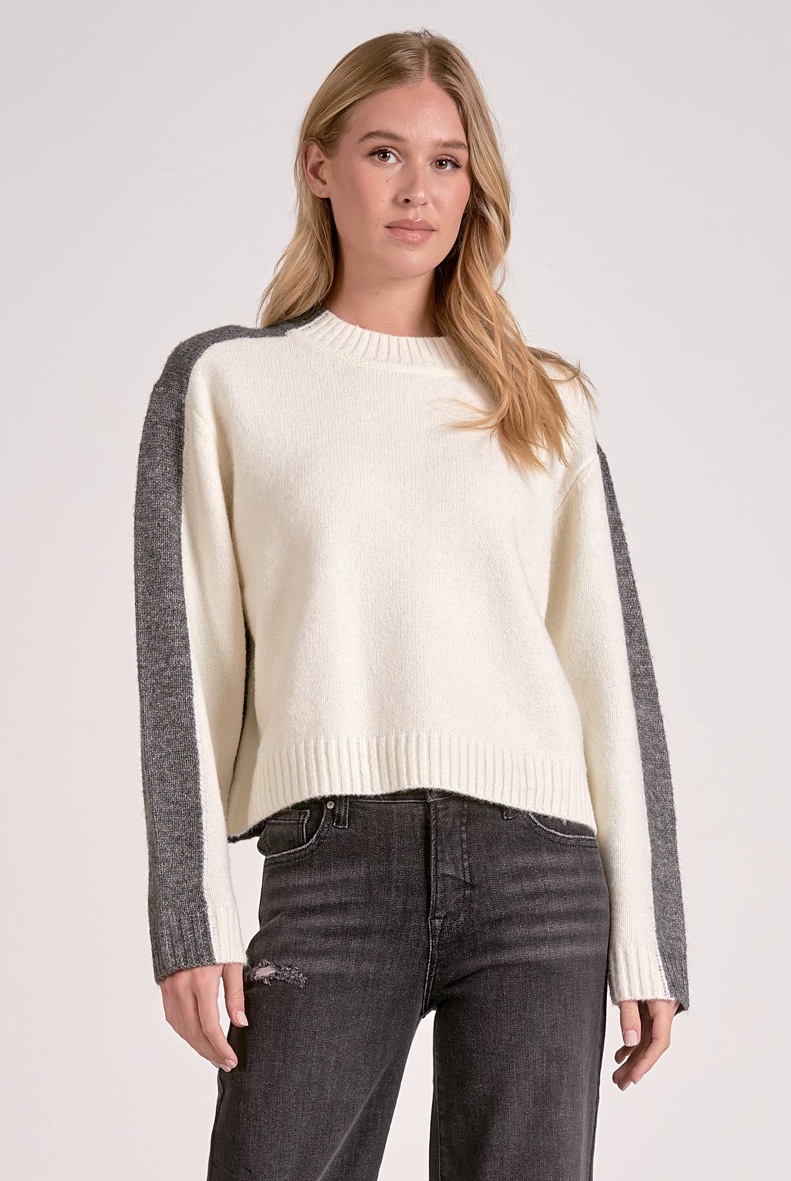 Front view of the white and grey color block crewneck sweater with soft knit and stripe sleeve effect