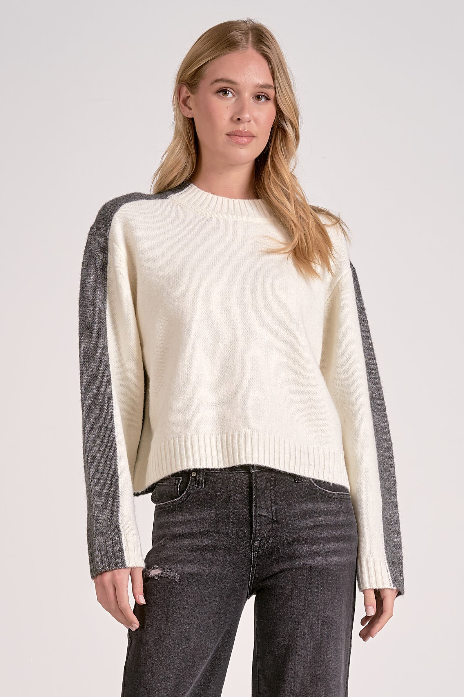 Front view of the white and grey color block crewneck sweater with soft knit and stripe sleeve effect