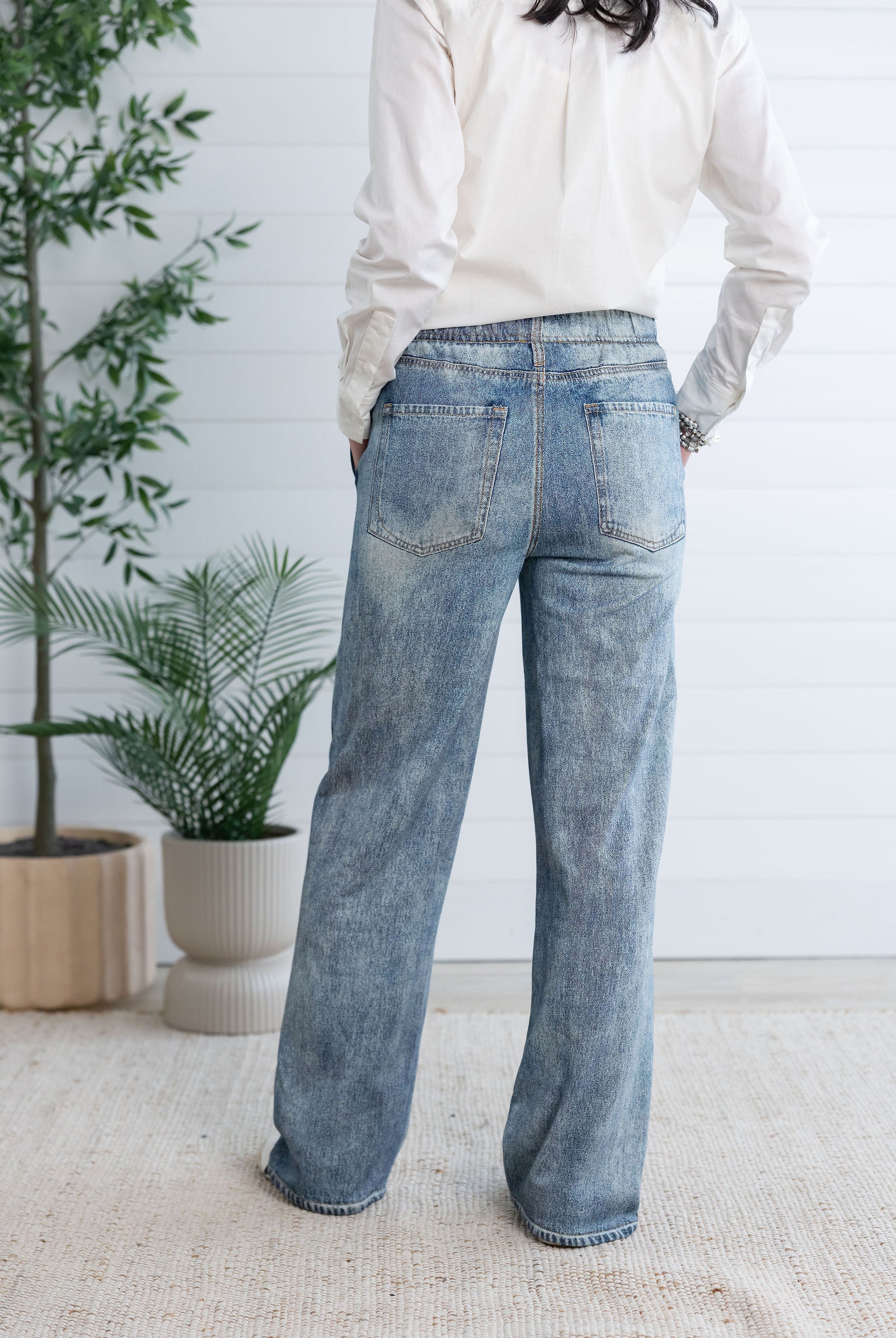 woman modeling back of lounge pant, the light blue Side Stripe Relaxed Denim Pant