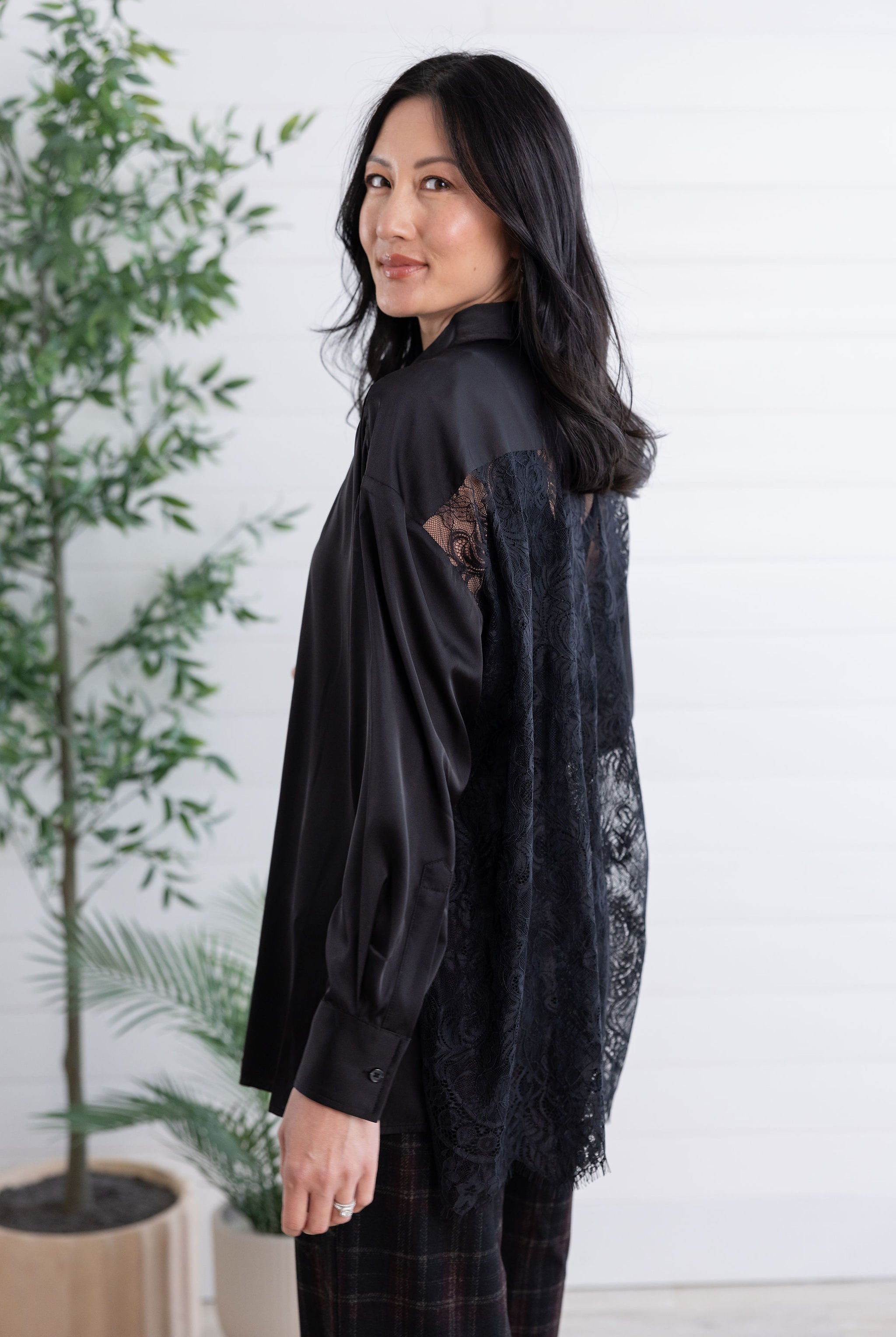 side view of black lace-back button down
