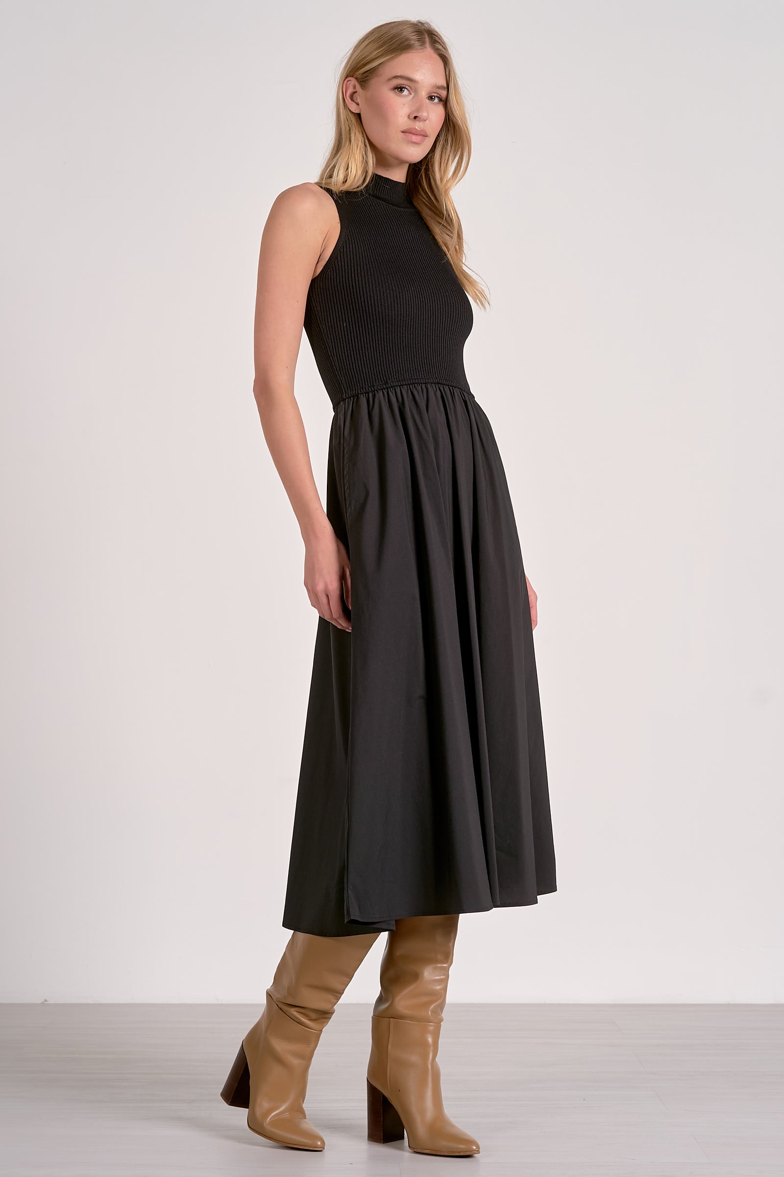 Side view of black sleeveless maxi dress with mock neck and mixed media ribbed bodice, versatile multi season style