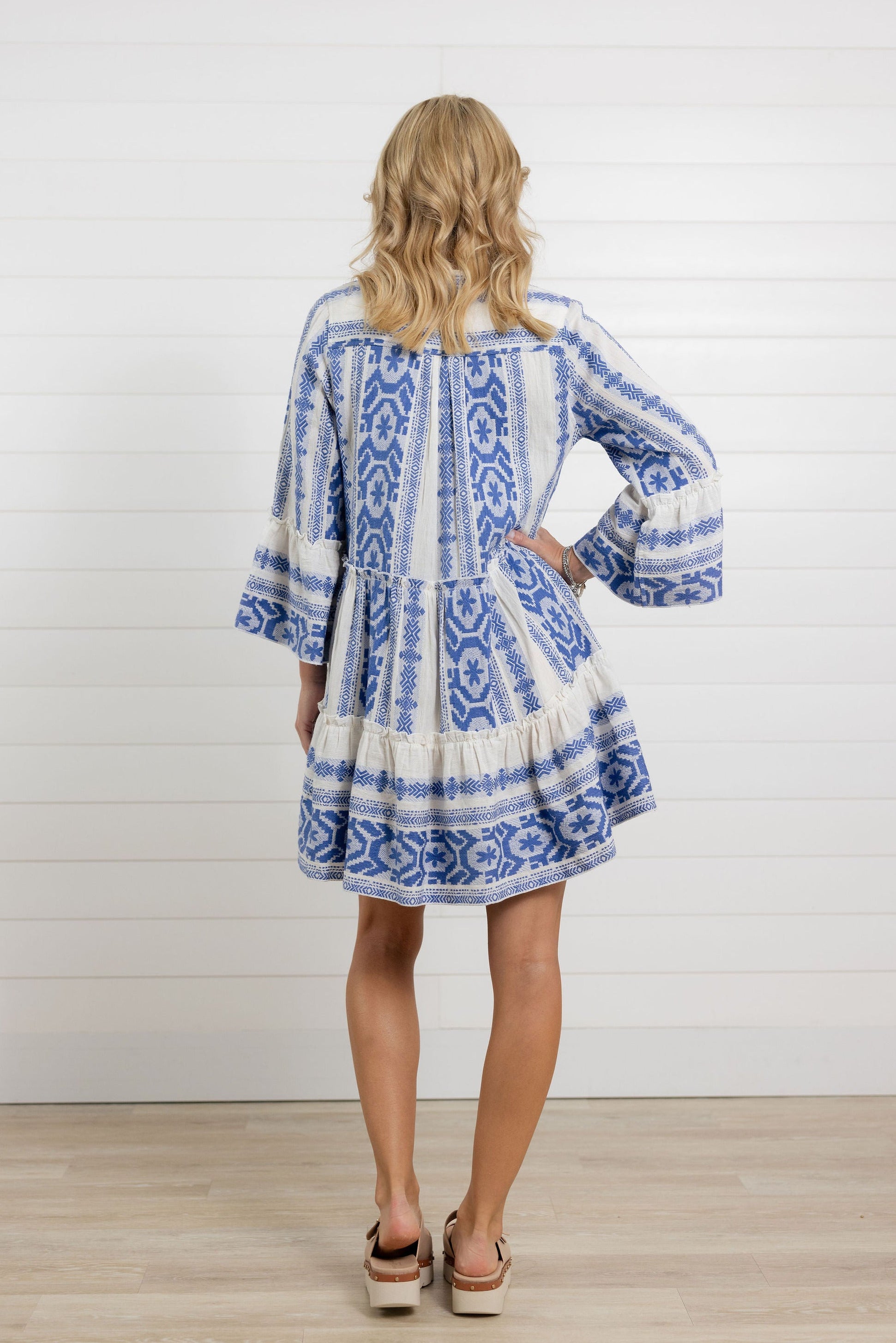 back of the blue tiered mini dress with bell sleeves