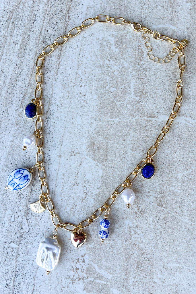 Gold chain necklace with blue white porcelain bead charms