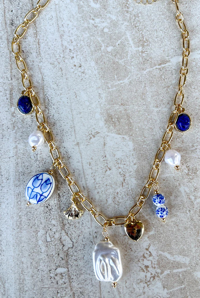 Blue and white porcelain charm necklace on gold chain