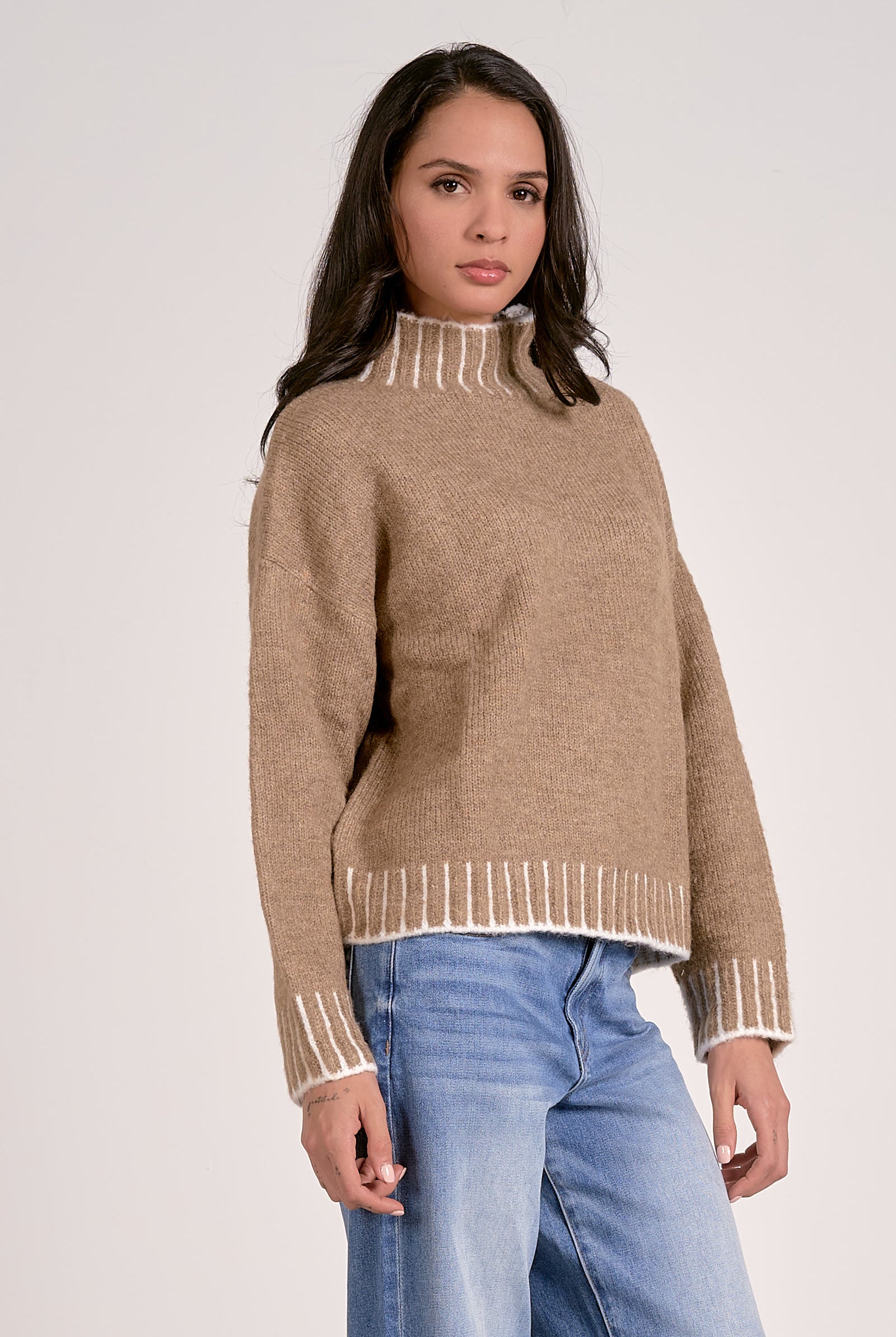 tan mock neck sweater with white whipstitch side view
