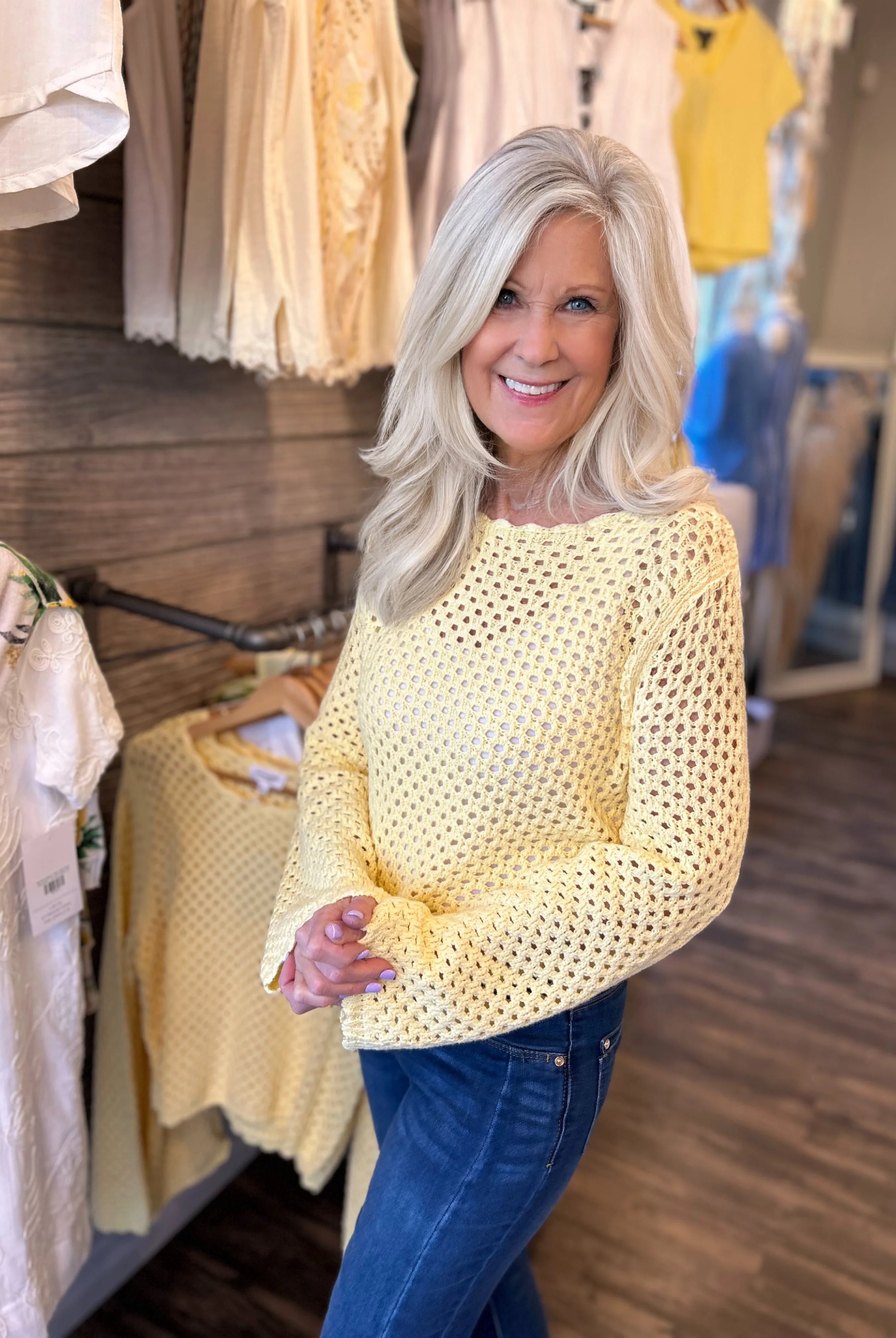 woman modeling the Crochet Open Knit Scallop Trim Sweater in butter yellow