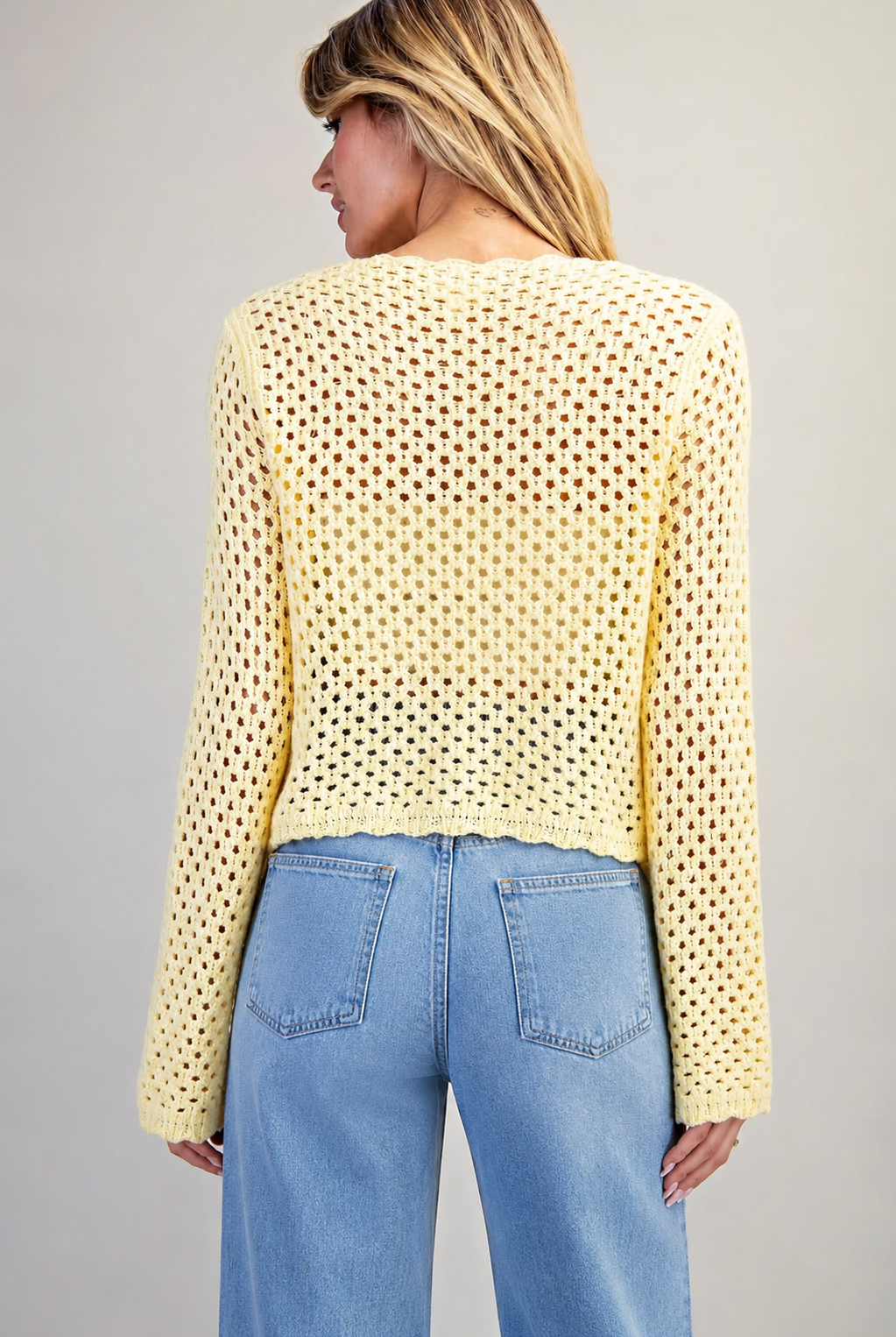 back of crochet open knit sweater with trim details in butter yellow