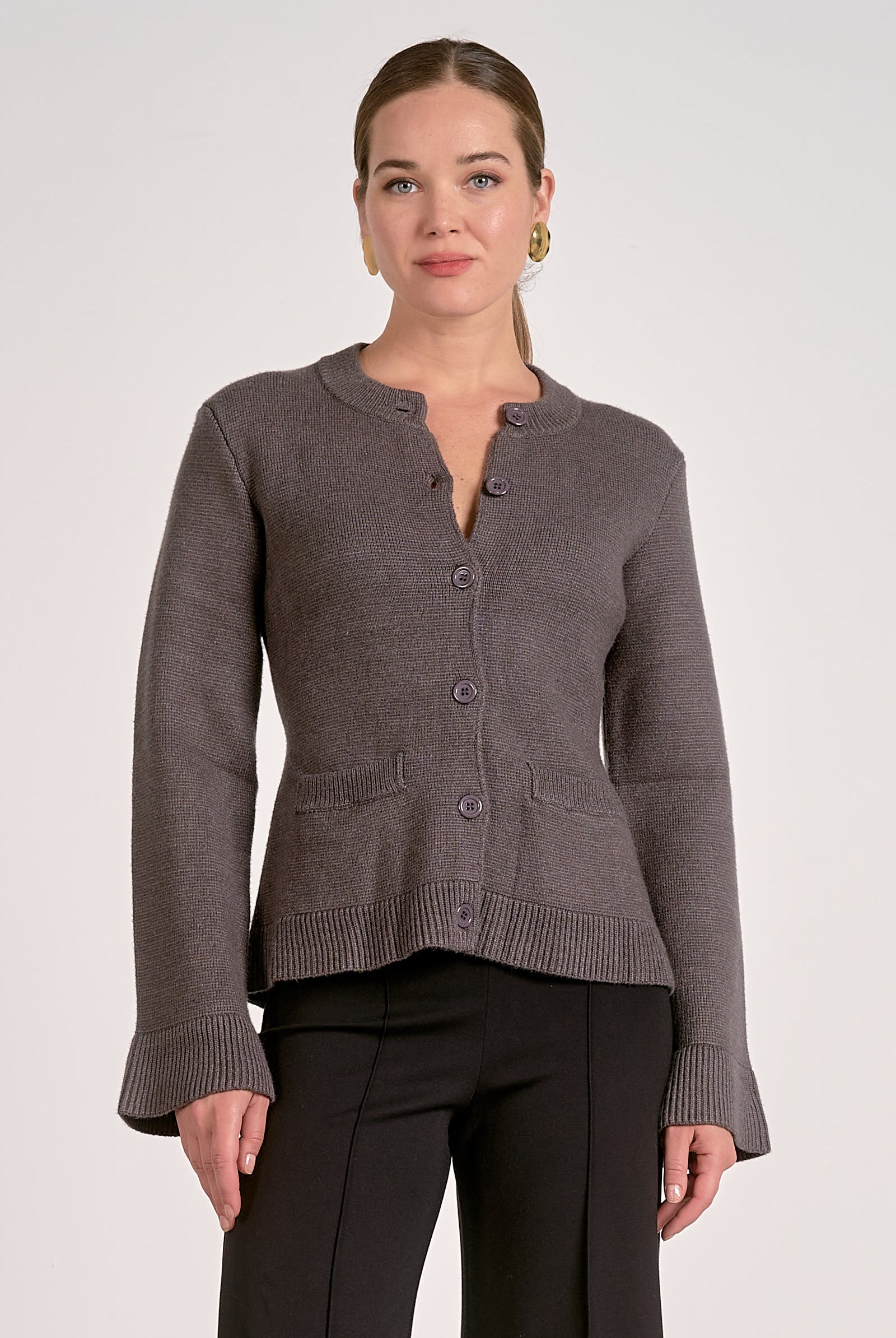 Woman showing the front view of the graphite flare cuff button cardigan front view