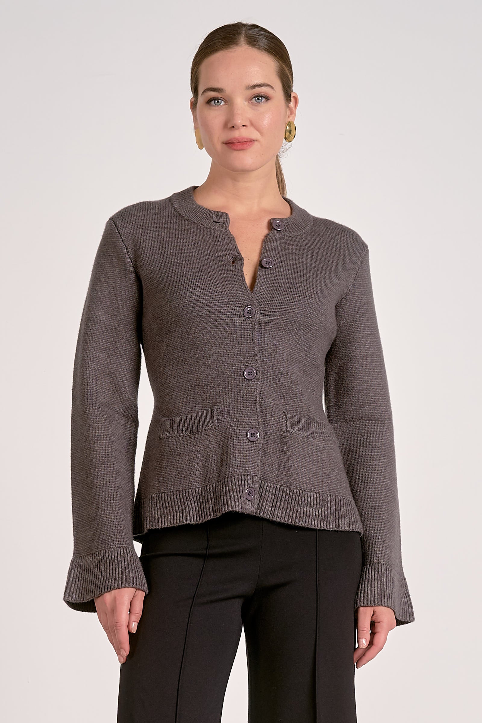Woman showing the front view of the graphite flare cuff button cardigan front view