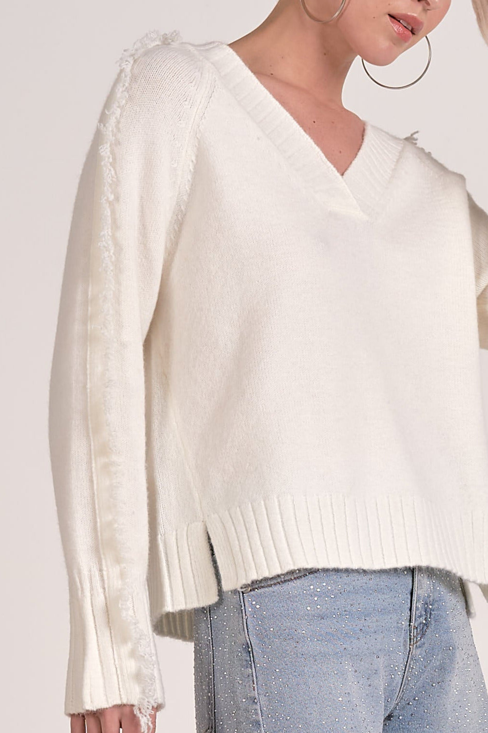details on the Willow Fringe V-Neck Sweater in ivory white fringe trim sleeves from Mainstream Boutique Bloomington