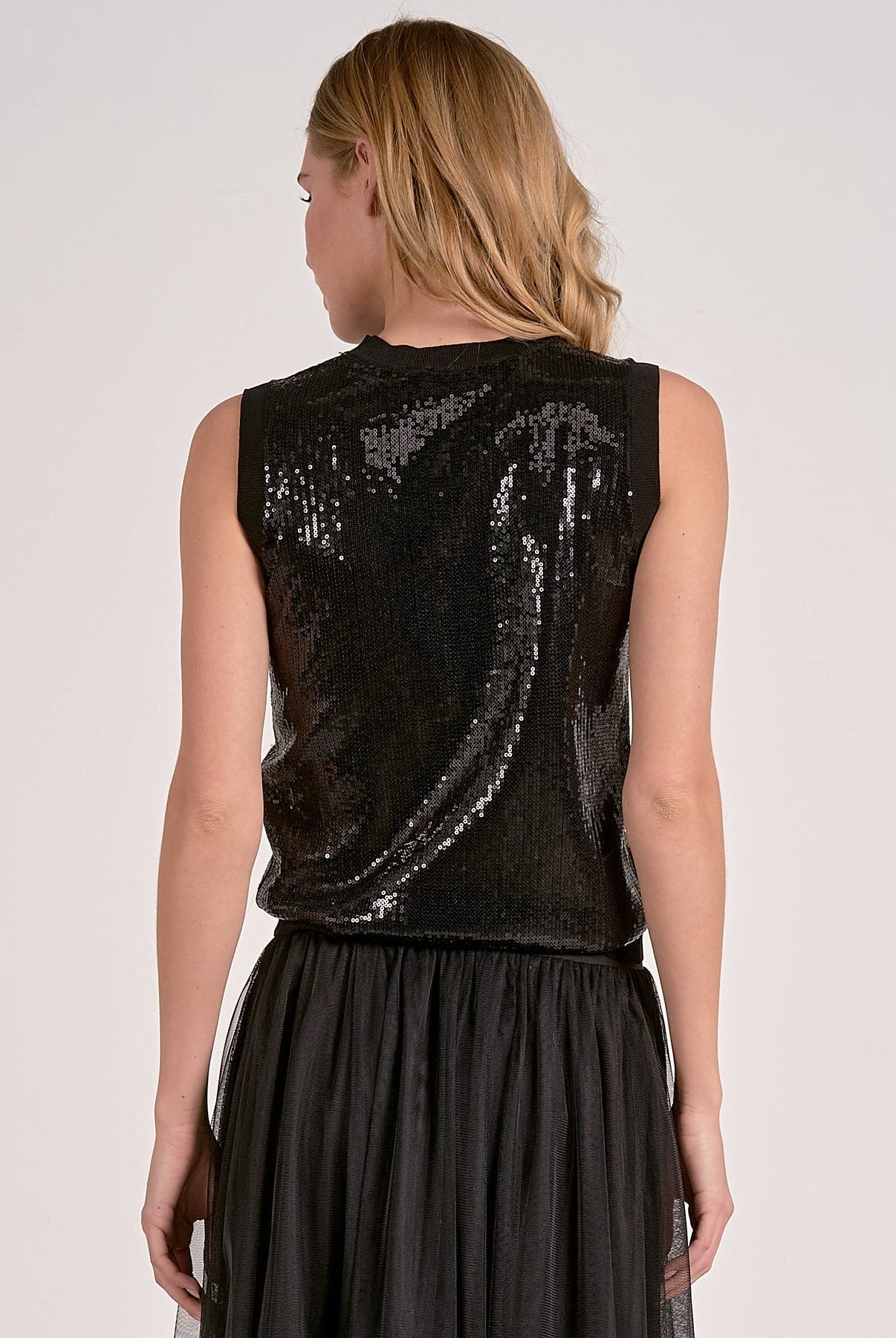 Woman modeling the back of the black sequin glitter tank top