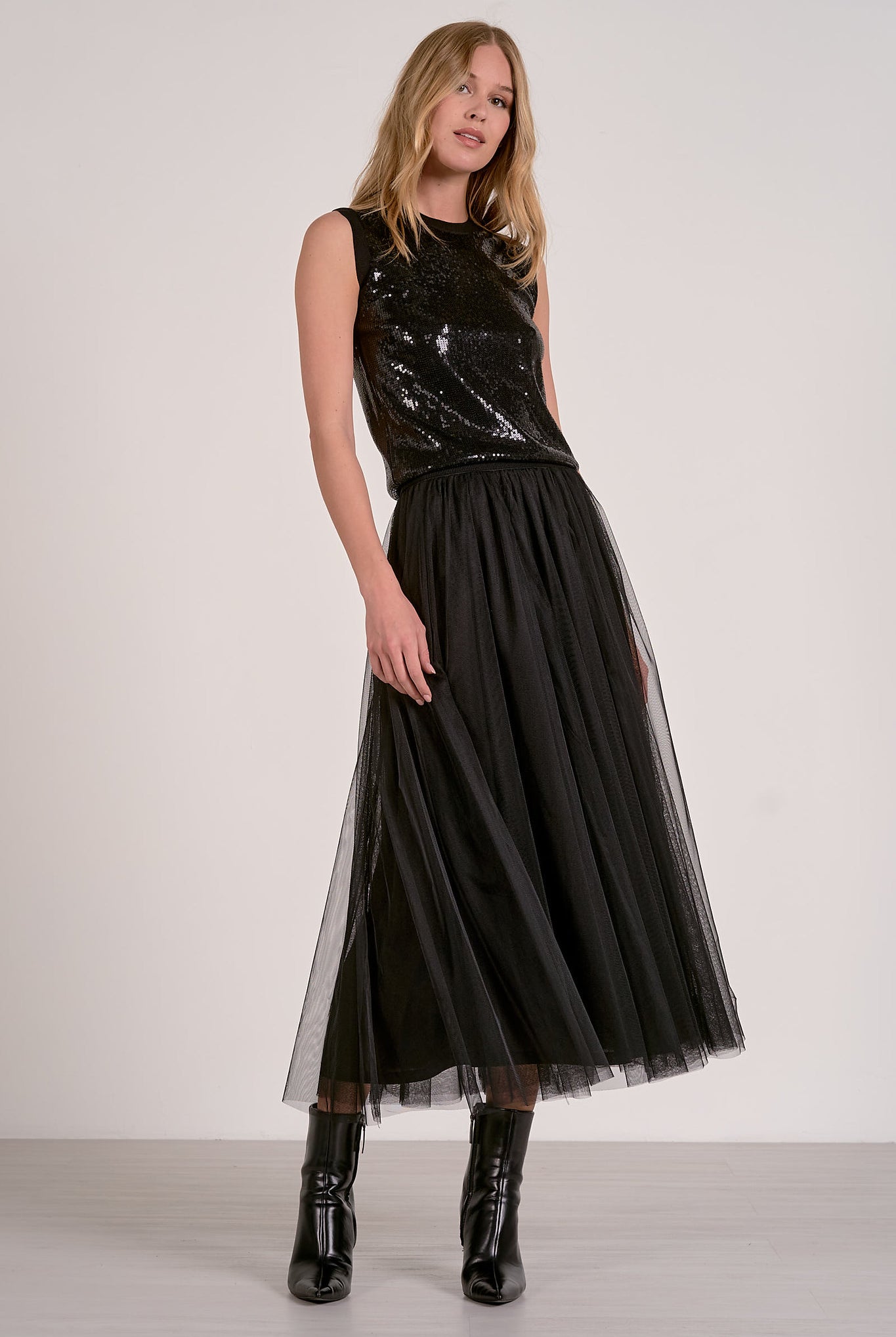 Woman modeling the black sequin glitter tank top and tulle skirt from Mainstream Boutique Bloomington
