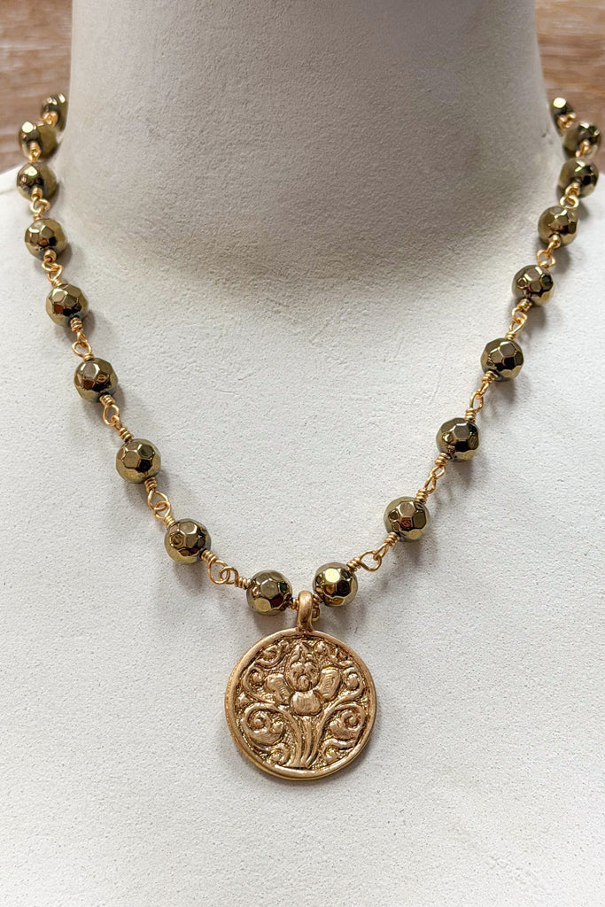 gold and bead necklace with solid coin pendant