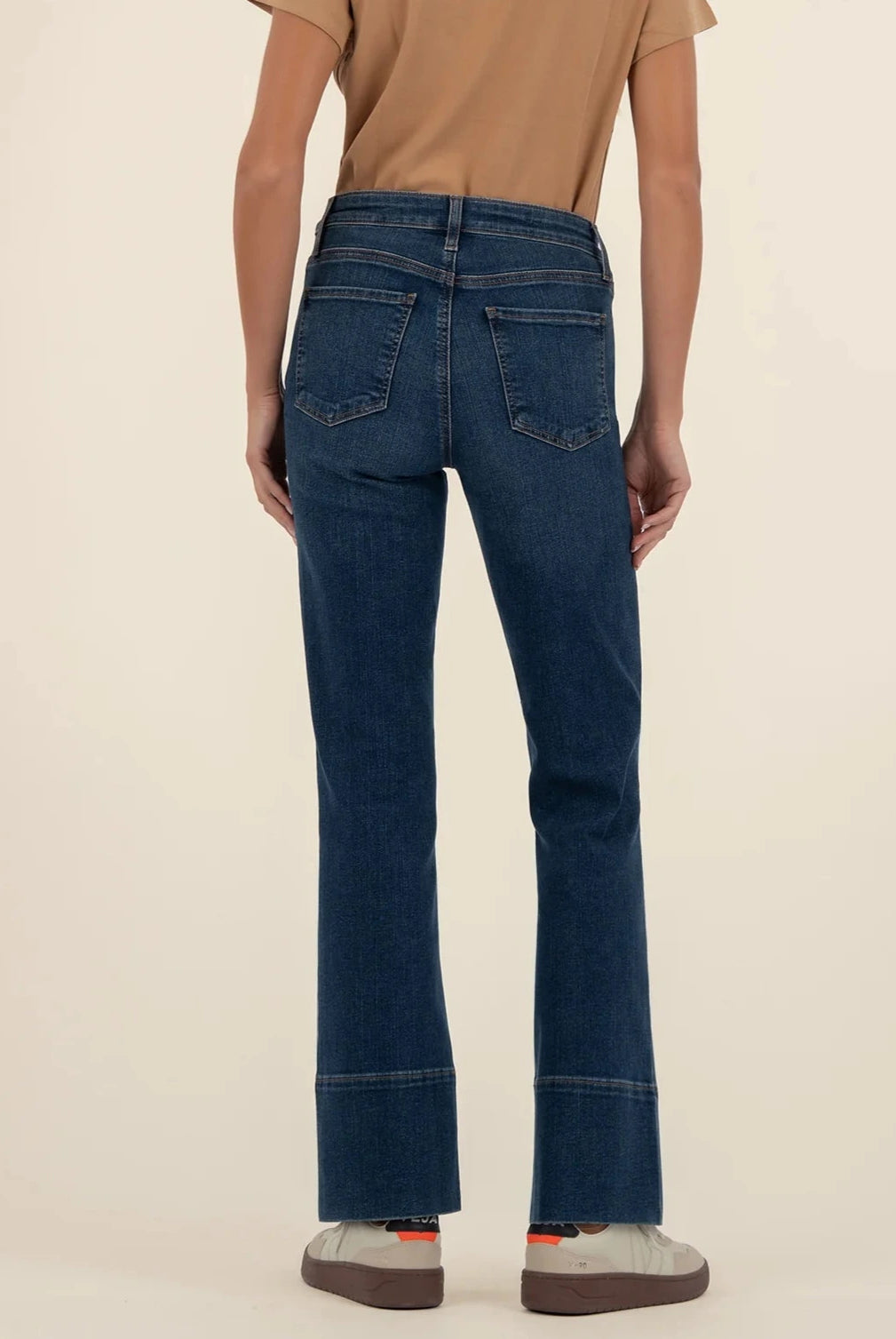 person showing the back of the kelsey hi-rise fab ab denim in the color envision or dark wash.