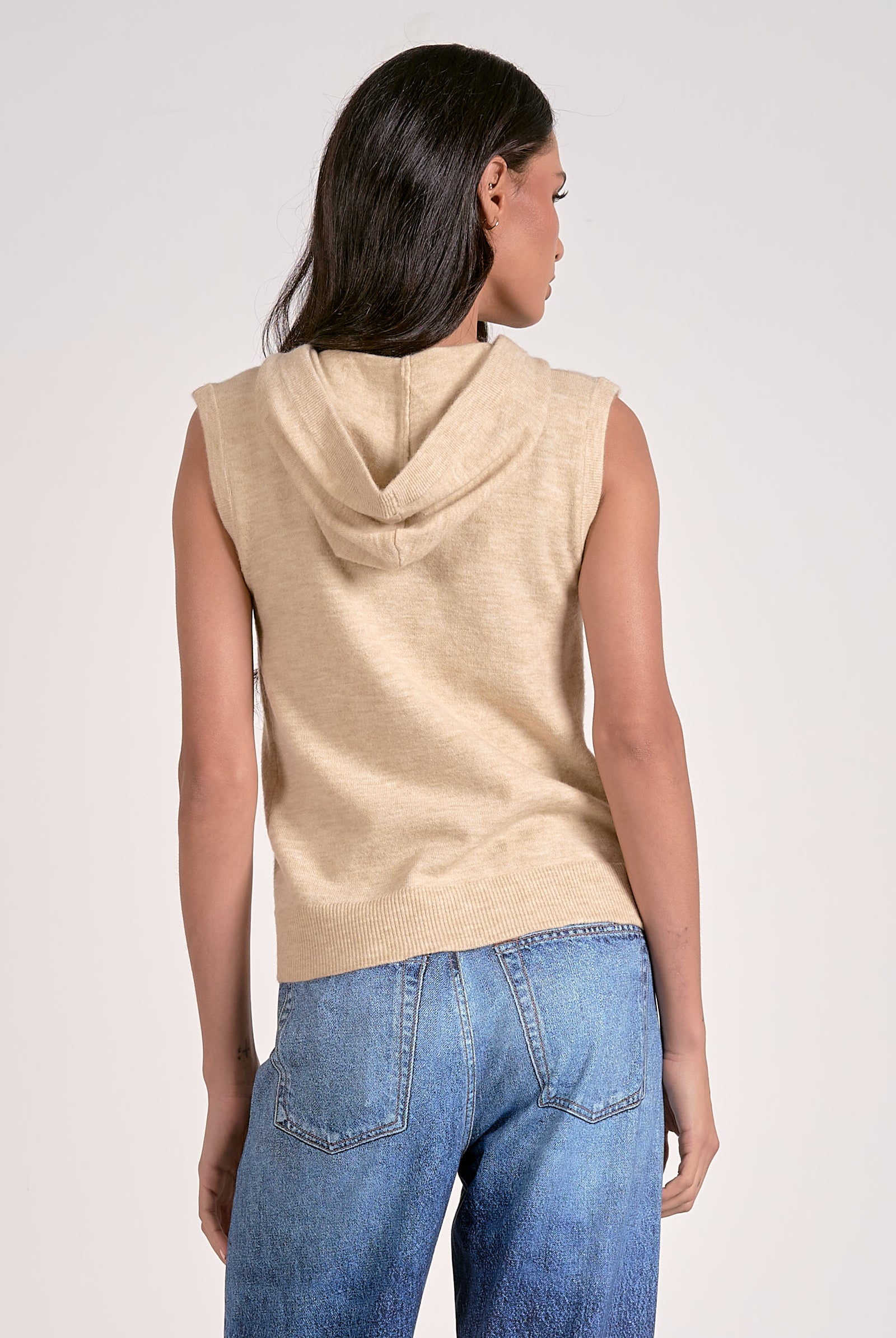Oatmeal knitted sleeveless hoodie with zip front, lightweight layering piece from Mainstream Boutique Bloomington