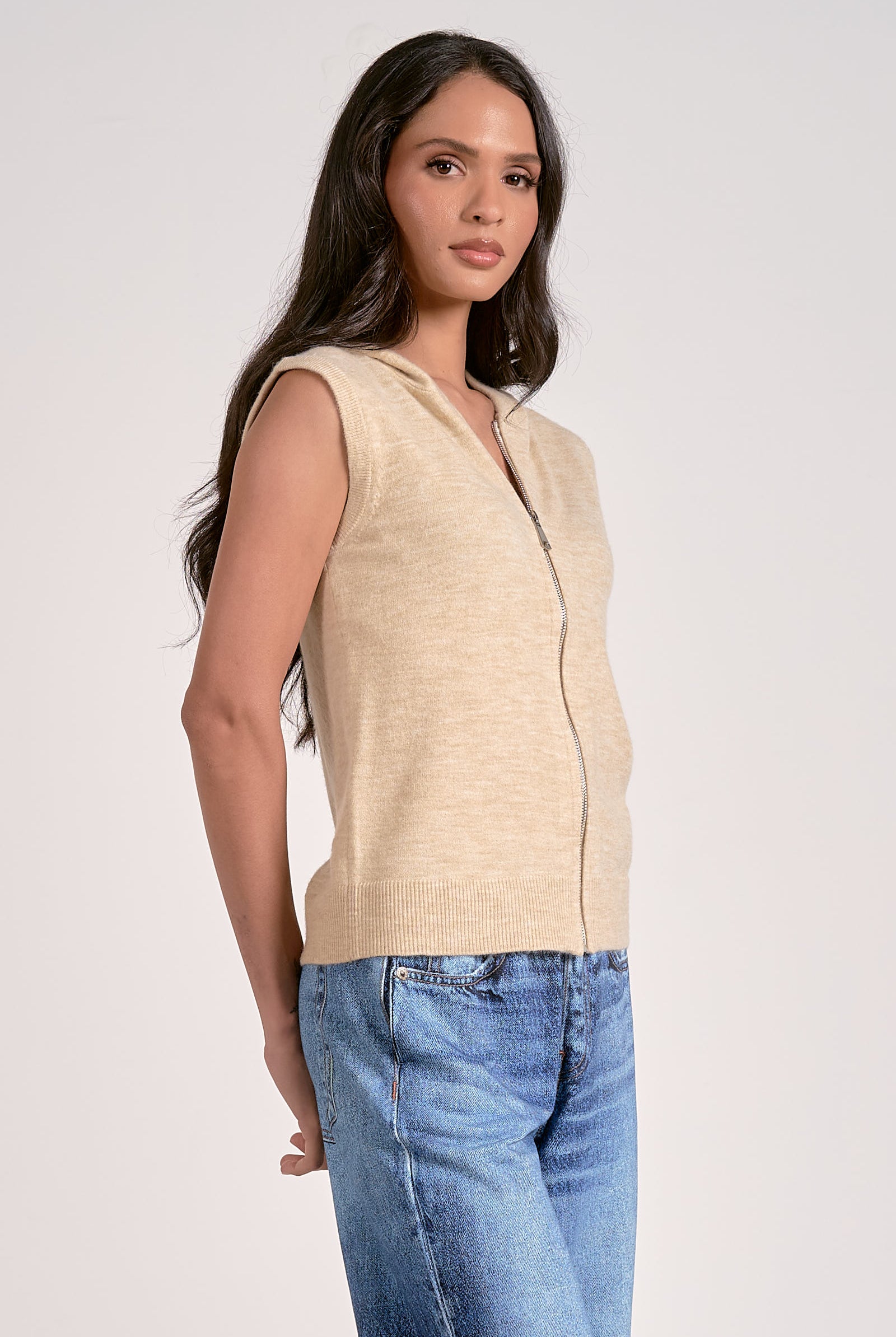 Oatmeal knitted sleeveless hoodie with zip front, lightweight layering piece from Mainstream Boutique Bloomington