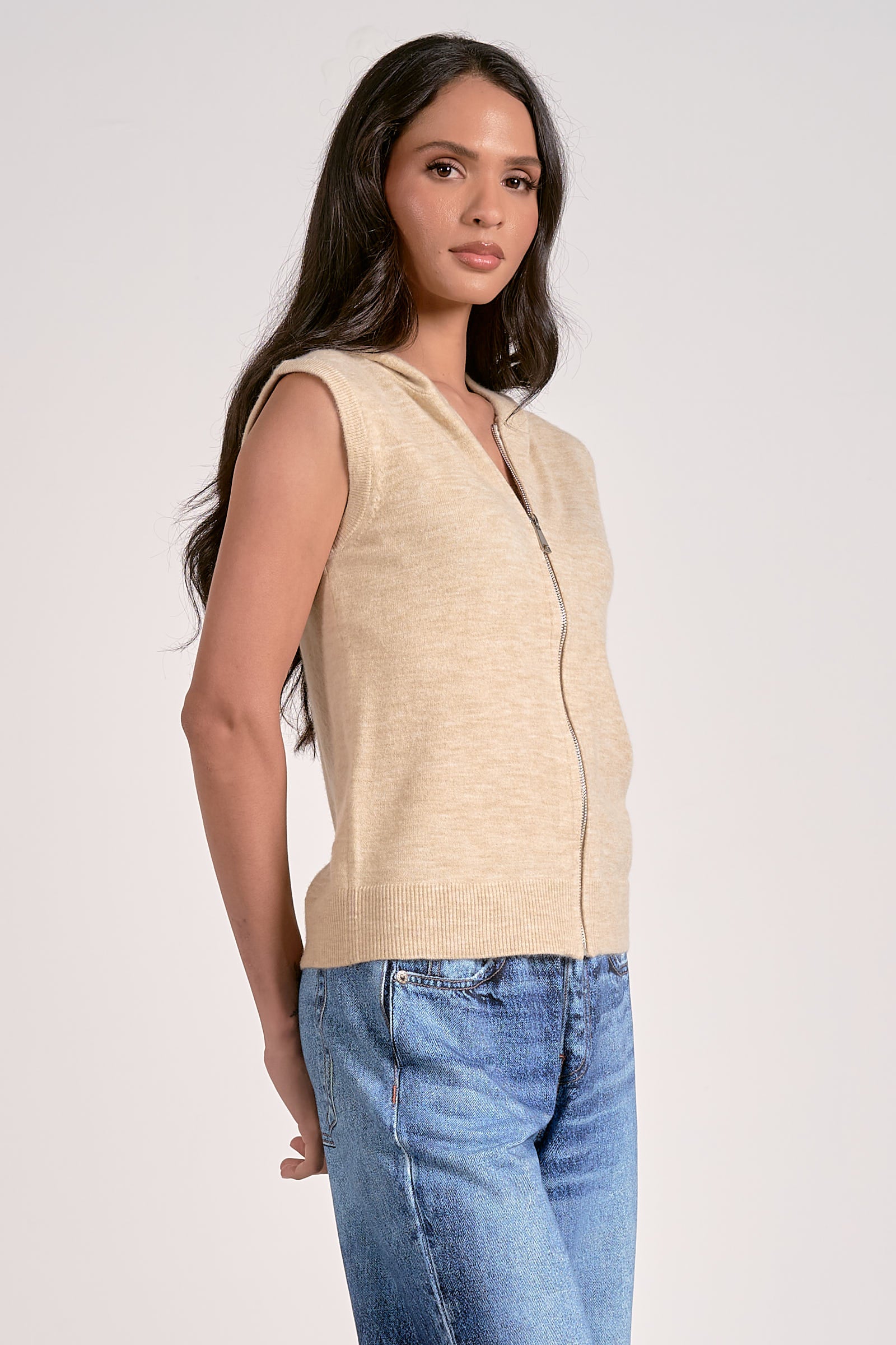 Oatmeal knitted sleeveless hoodie with zip front, lightweight layering piece from Mainstream Boutique Bloomington