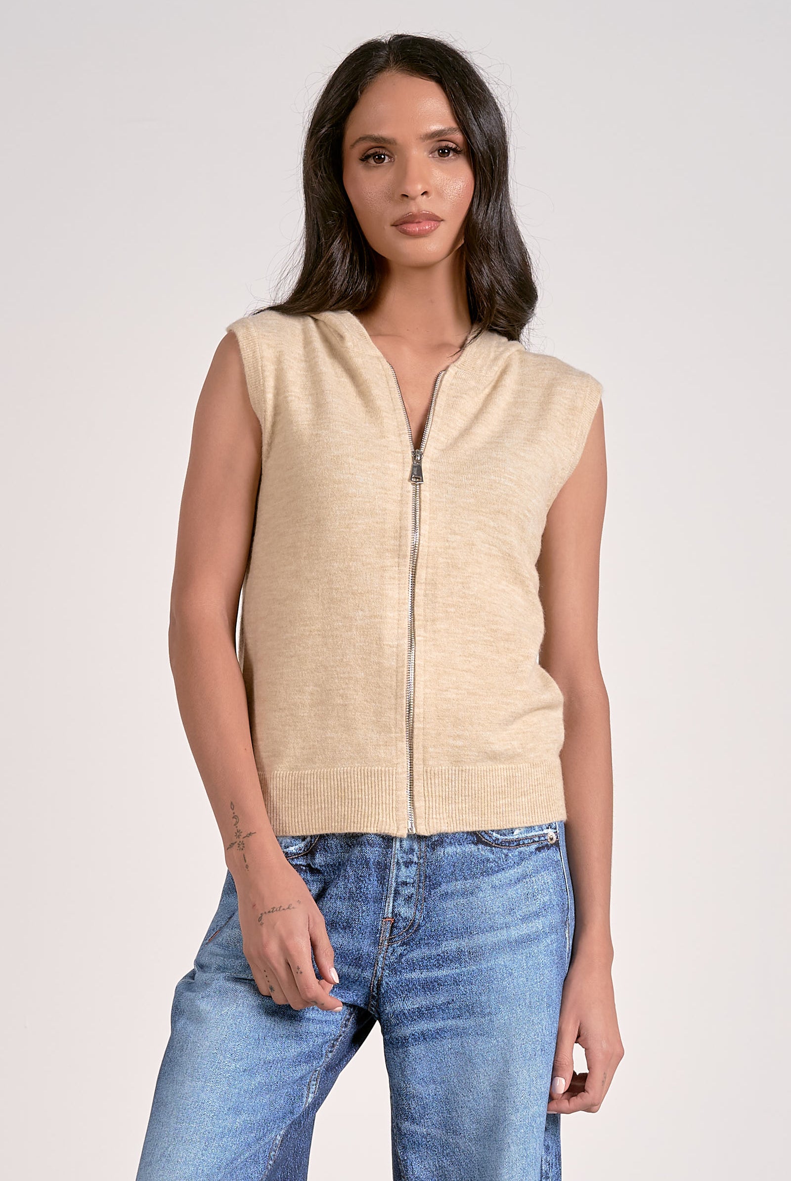 Oatmeal knitted sleeveless hoodie with zip front, lightweight layering piece from Mainstream Boutique Bloomington