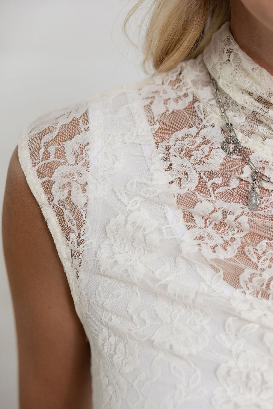 close up view of Mac and Me ivory lace mock neck fitted top