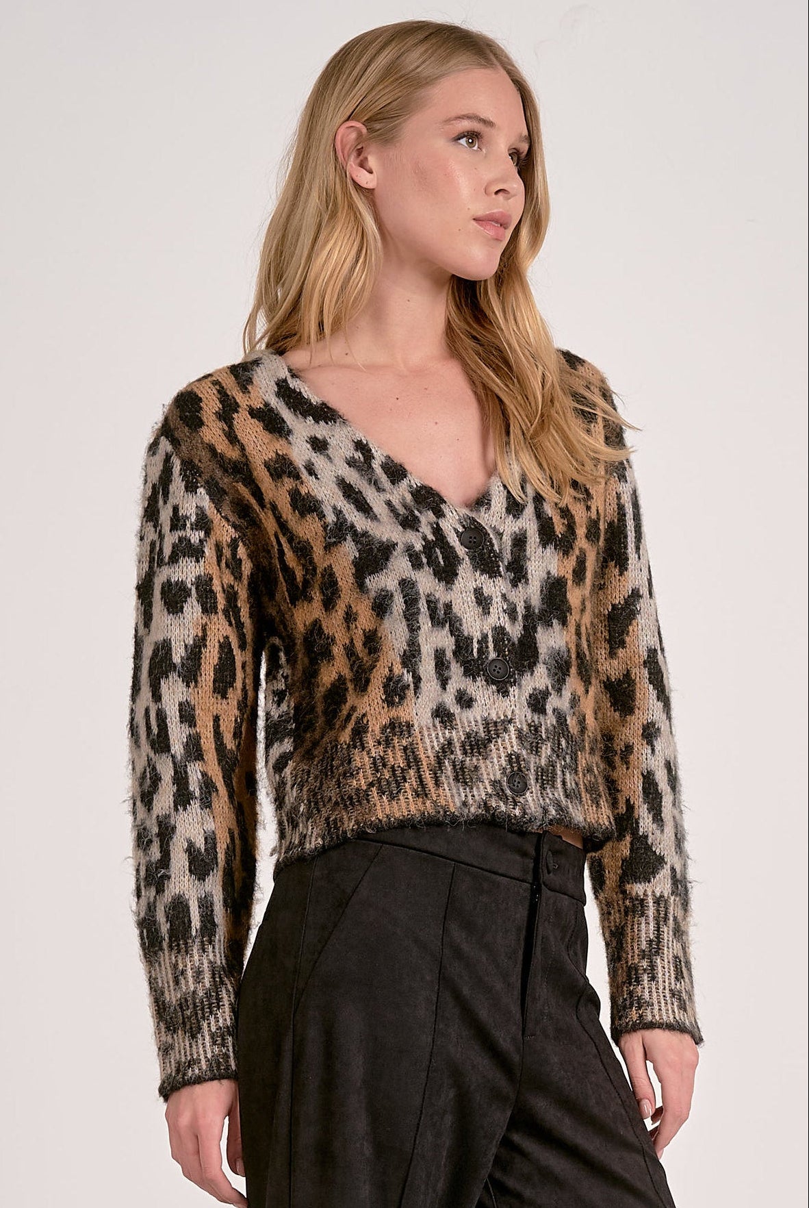 Model wearing Meet & Greet Eyelash Leopard Cardigan in fuzzy eyelash knit with leopard print and button-front closure from Mainstream Boutique Bloomington