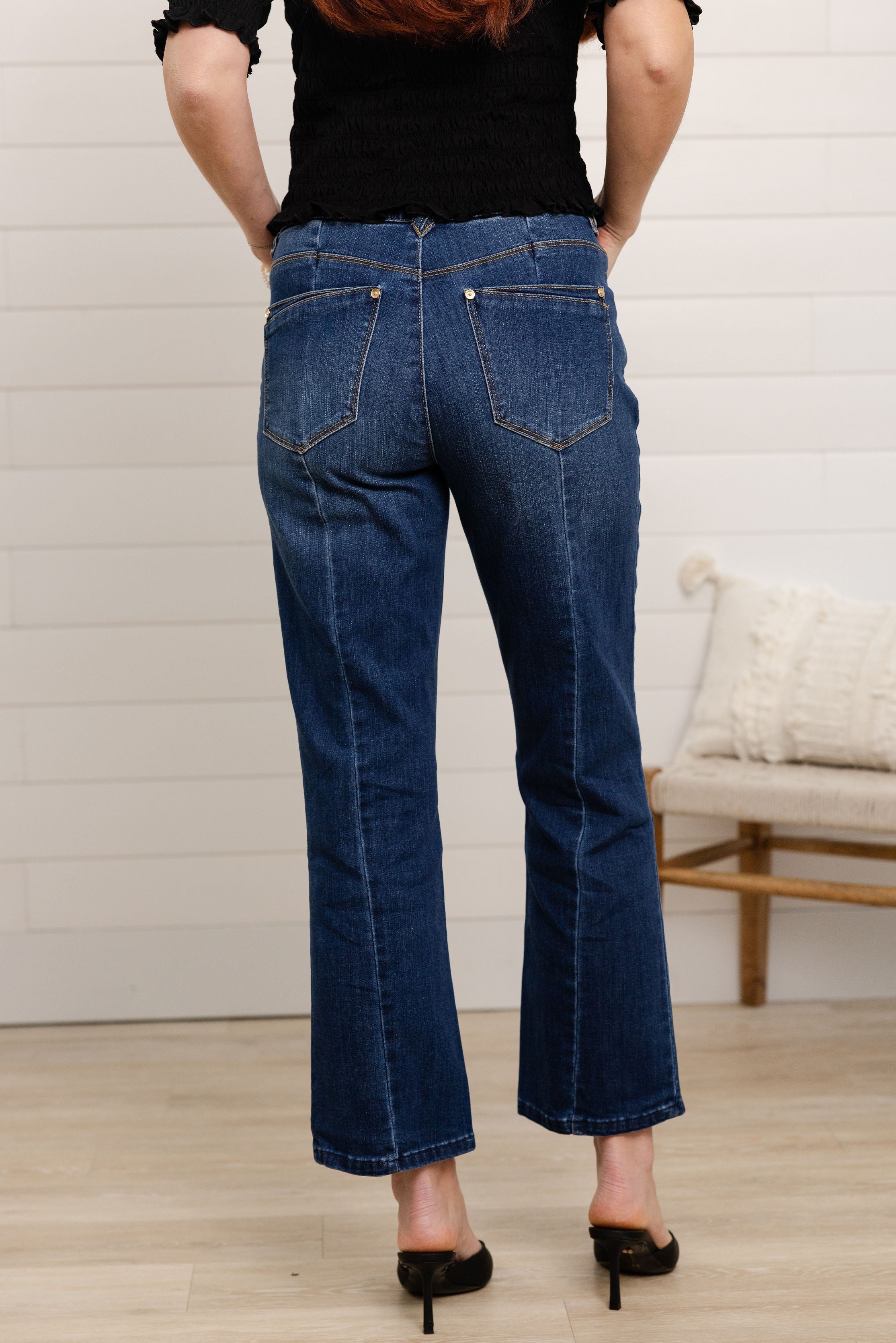 woman modeling back of w mac and me barely boot denim in dark blue color with black top by Mac and Me