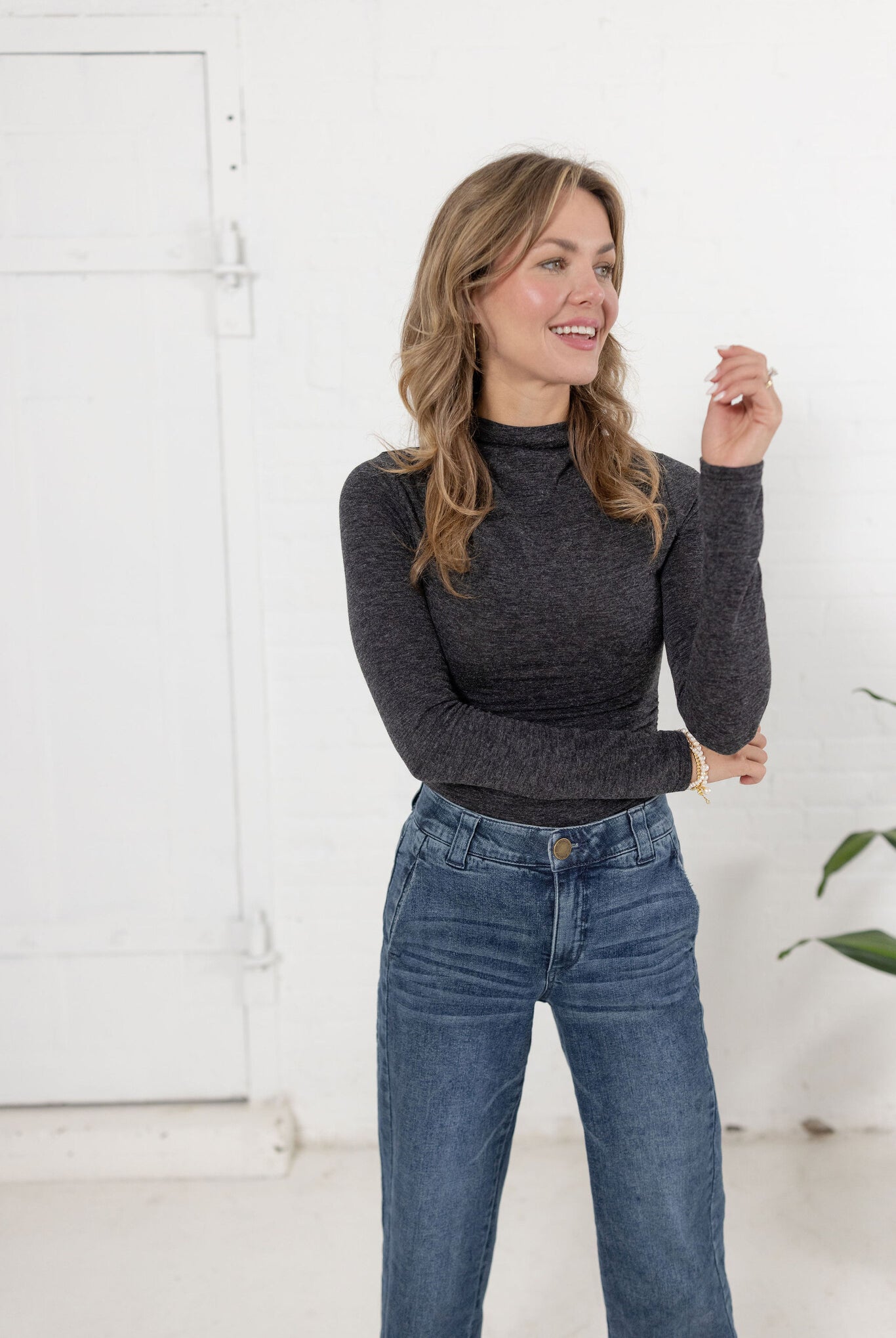 woman modeling Mock Neck Side Ruched Top in brushed grey with Mac and Me jeans.