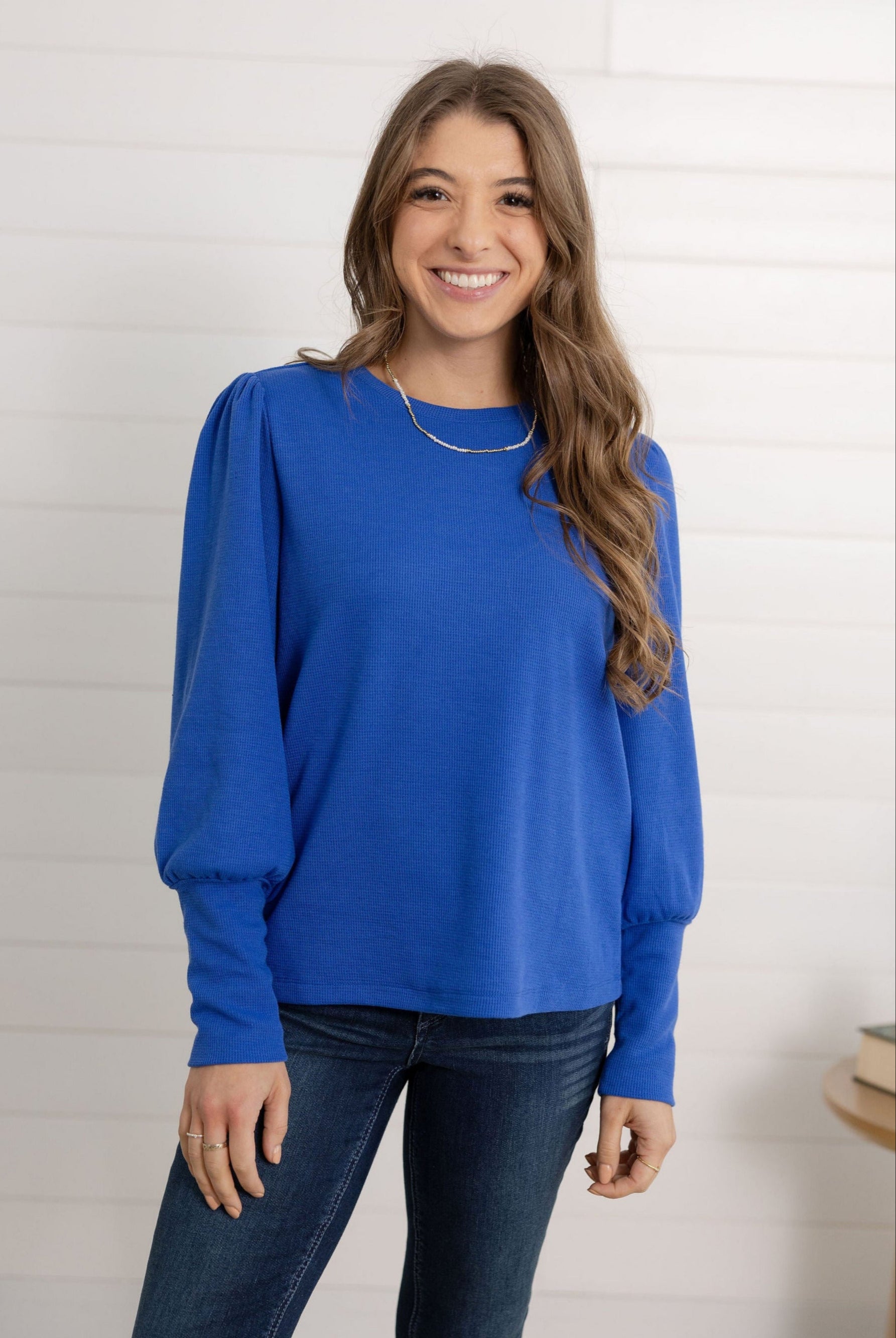 Mac modeling the gathered shoulder rib top in blue.