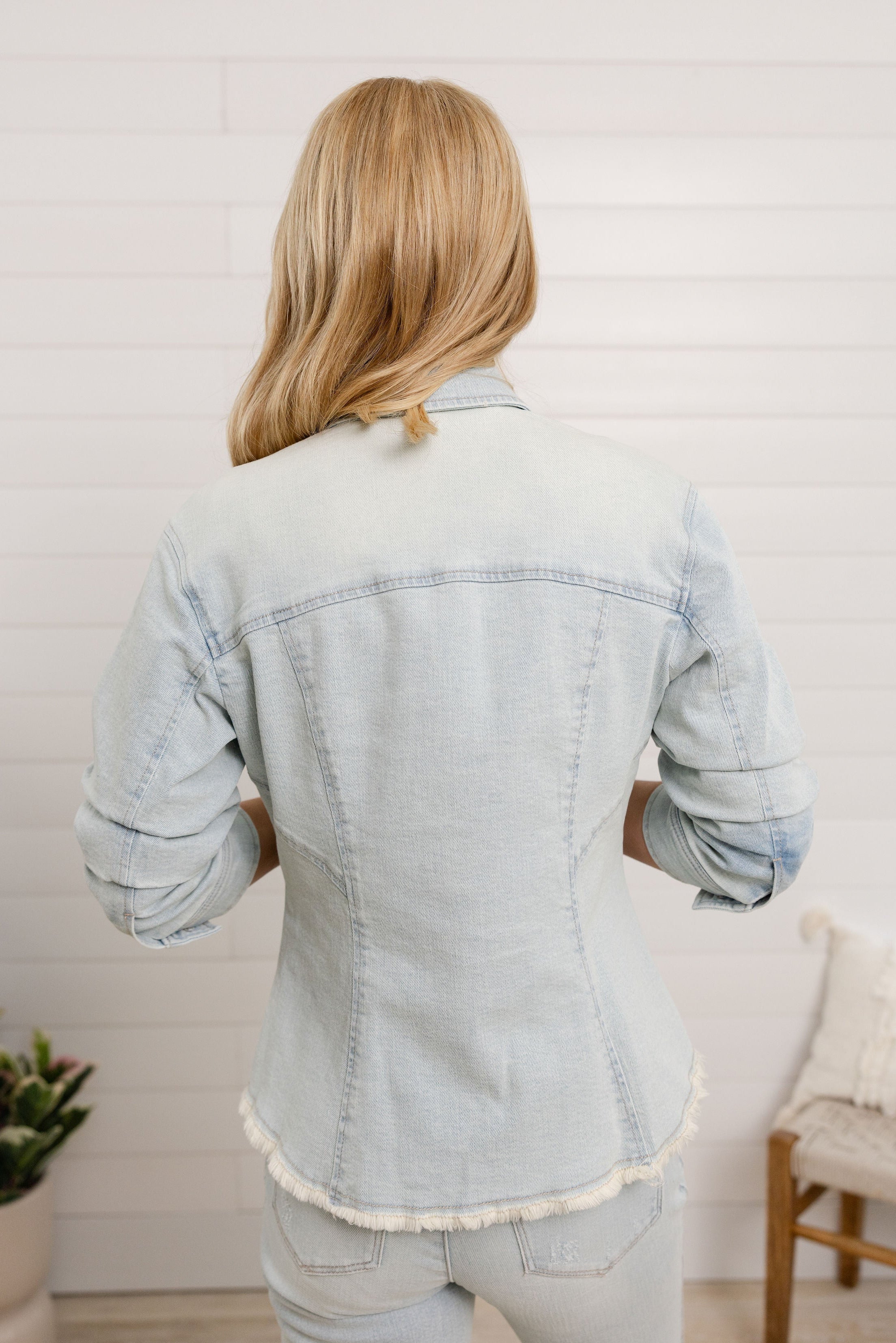 back view of Mac and Me bleached blue ruched sleeve denim jacket with fray hem