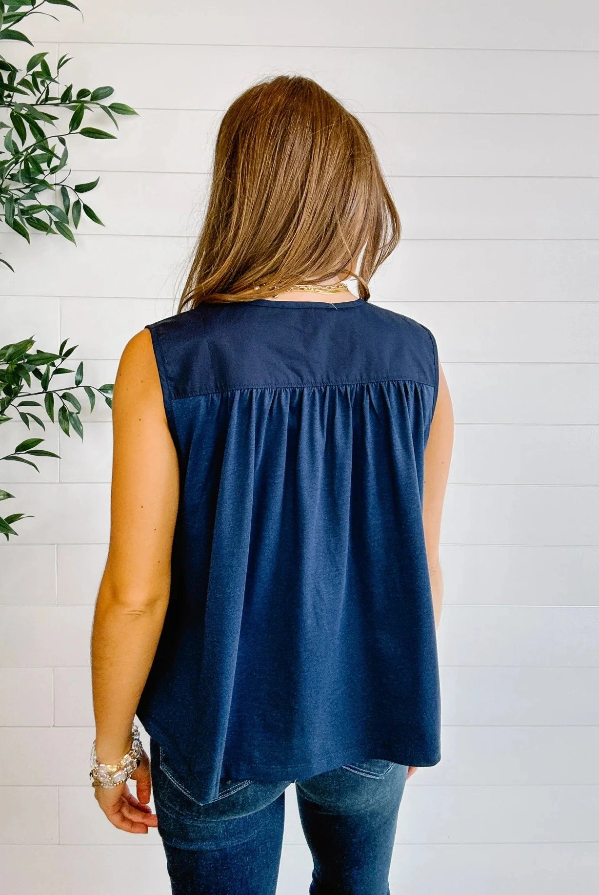 Back view of navy sleeveless gathered blouse for women