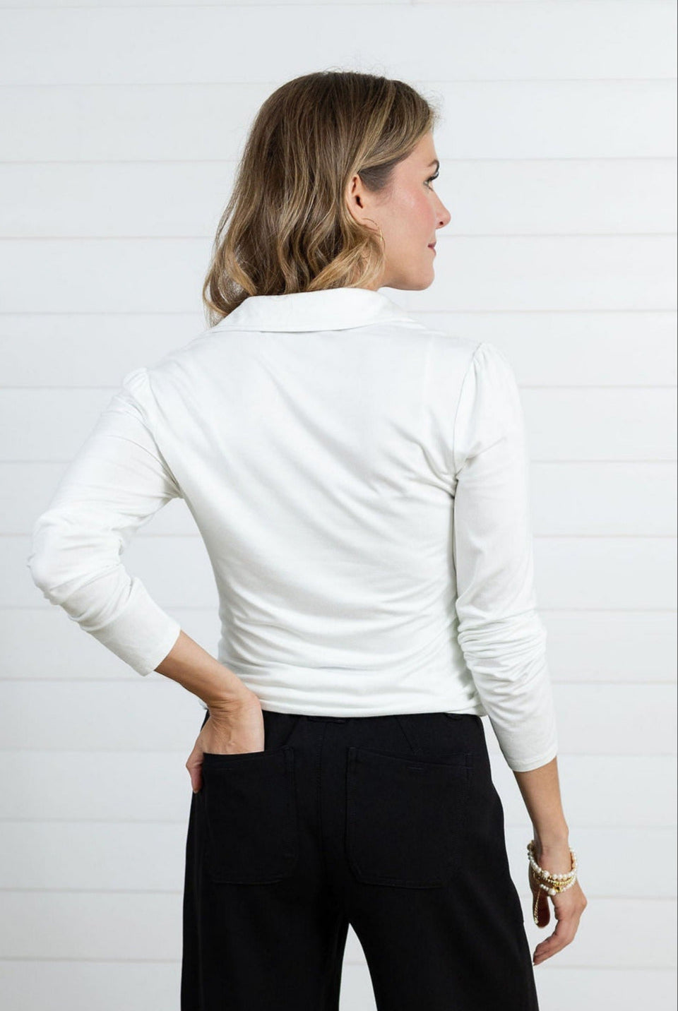 Woman modeling the back of the v-neck mac and me ruched button down top in ivory.