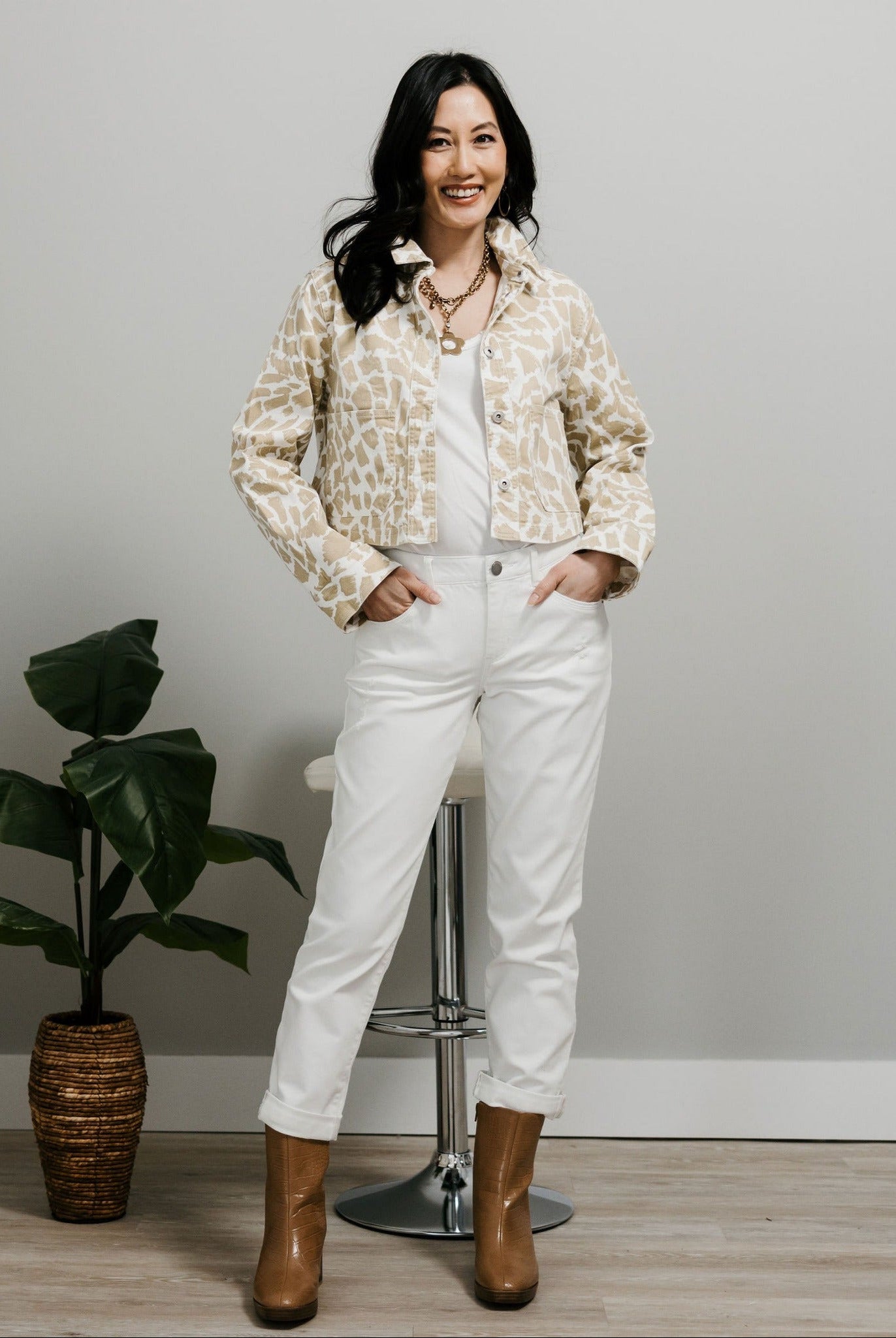 White girlfriend jeans styled with booties and a jacket for a fall-ready outfit