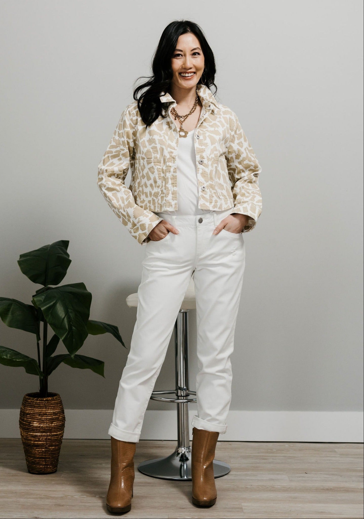 White girlfriend jeans styled with booties and a jacket for a fall-ready outfit