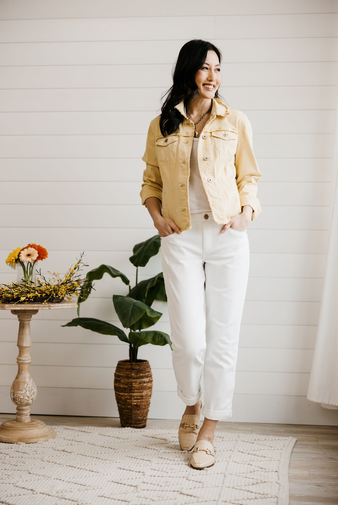 White girlfriend jeans styled with flats for a spring transitional outfit