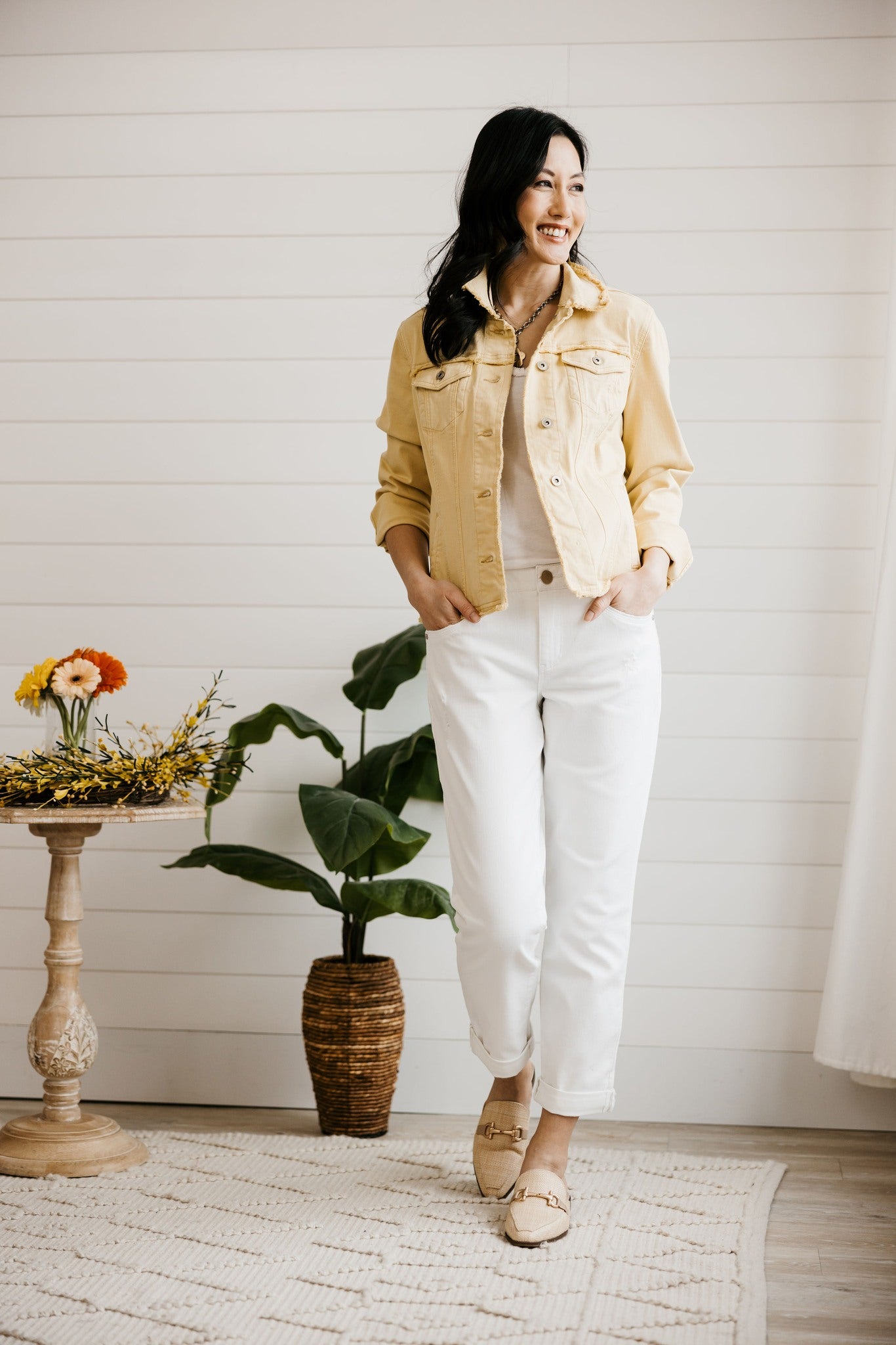 White girlfriend jeans styled with flats for a spring transitional outfit