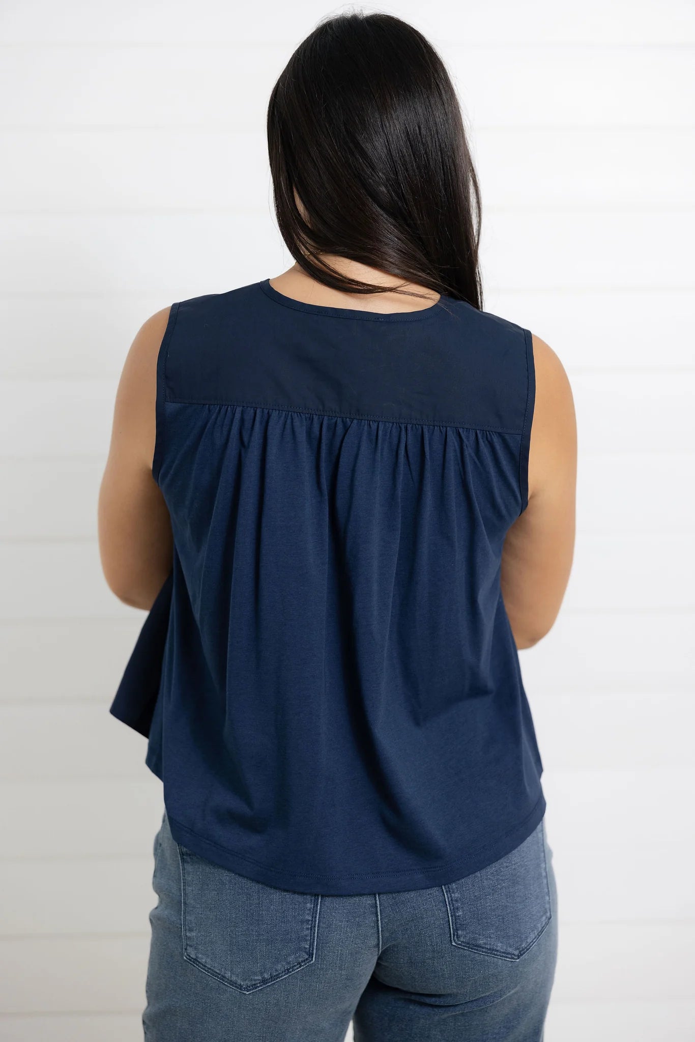 Back view of navy sleeveless gathered blouse for women
