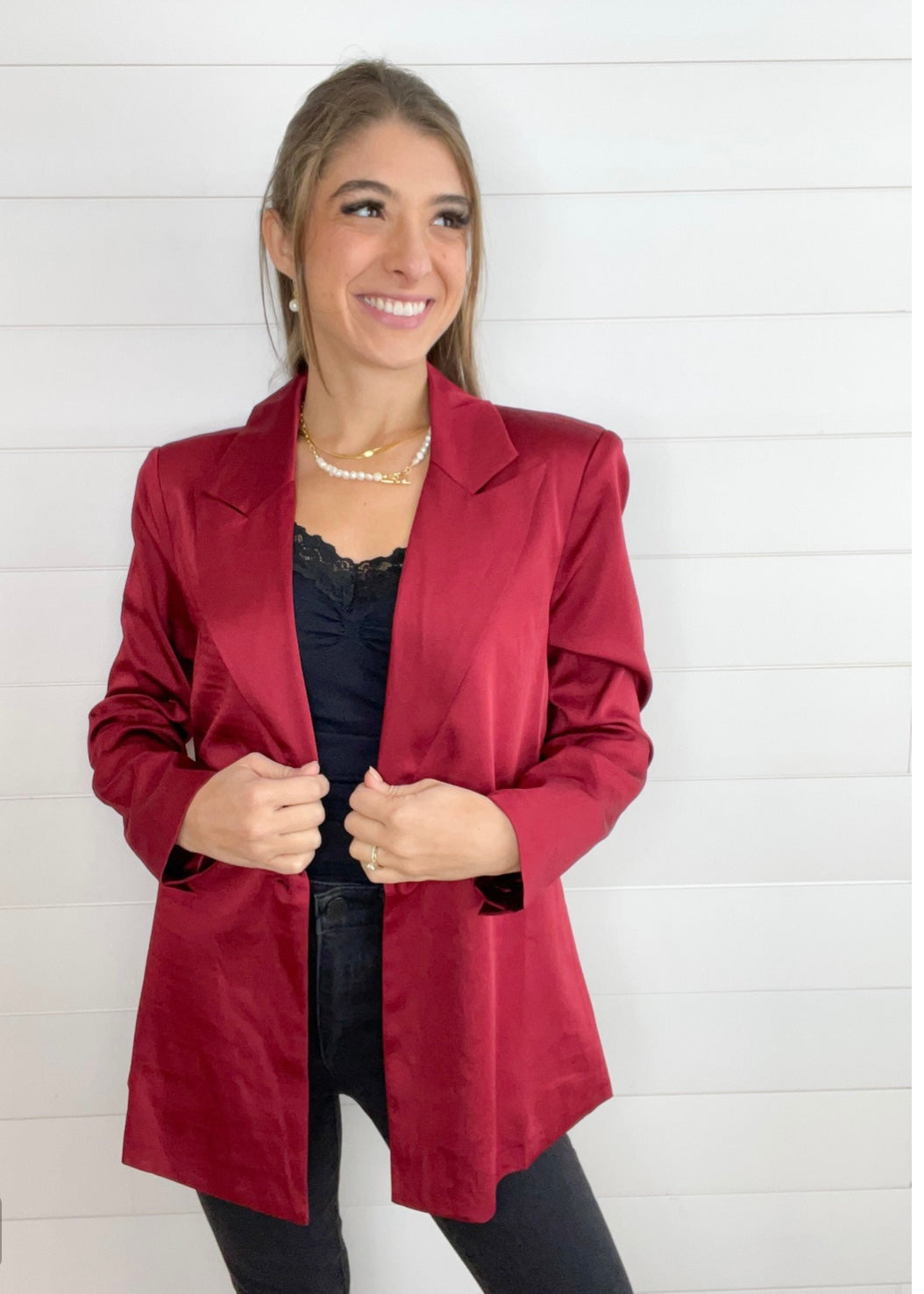 maroon satin tailored blazer on hanger with structured silhouette