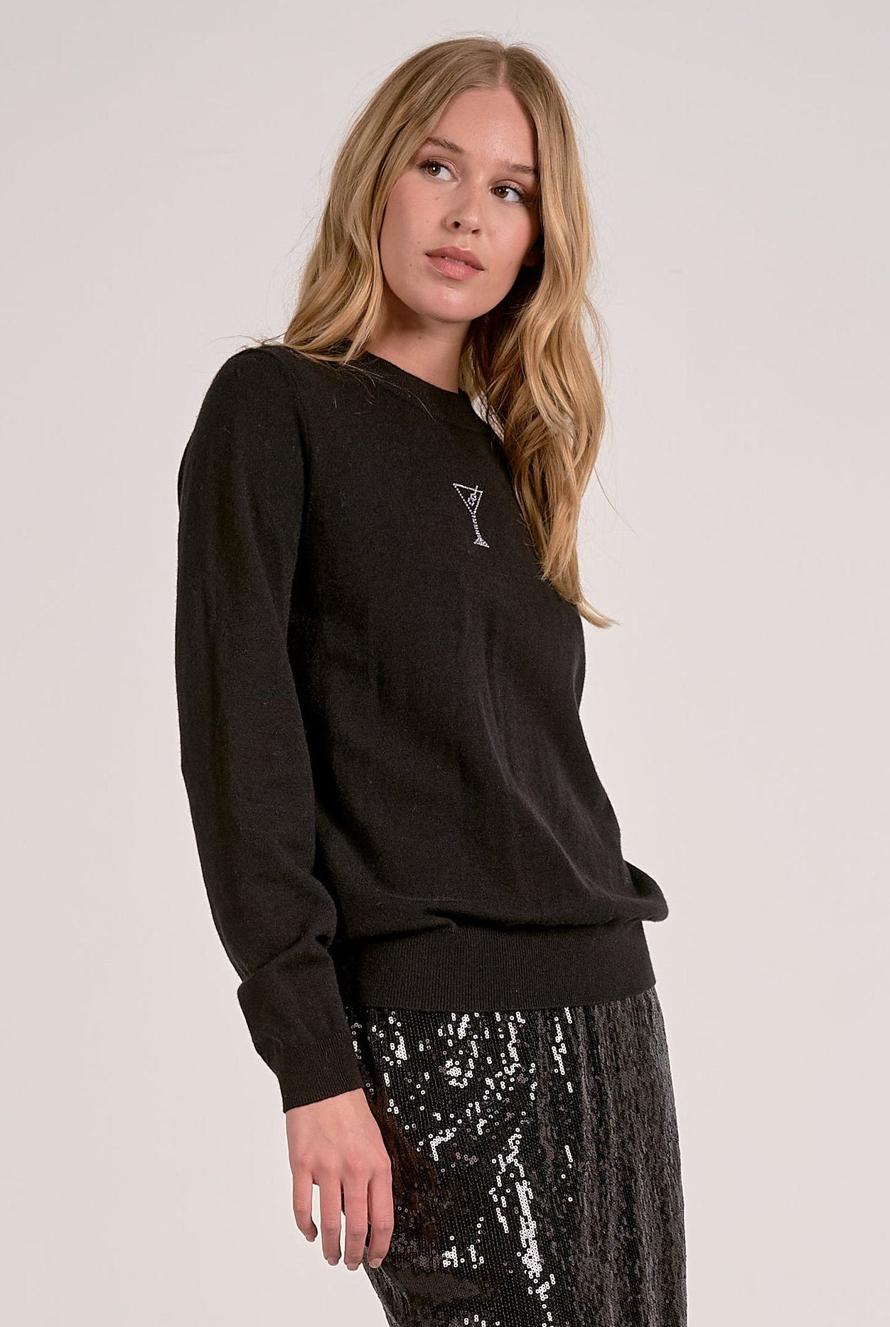 Model wearing black Martini Crewneck Sweater with rhinestone martini glass detail from Mainstream Boutique Bloomington
