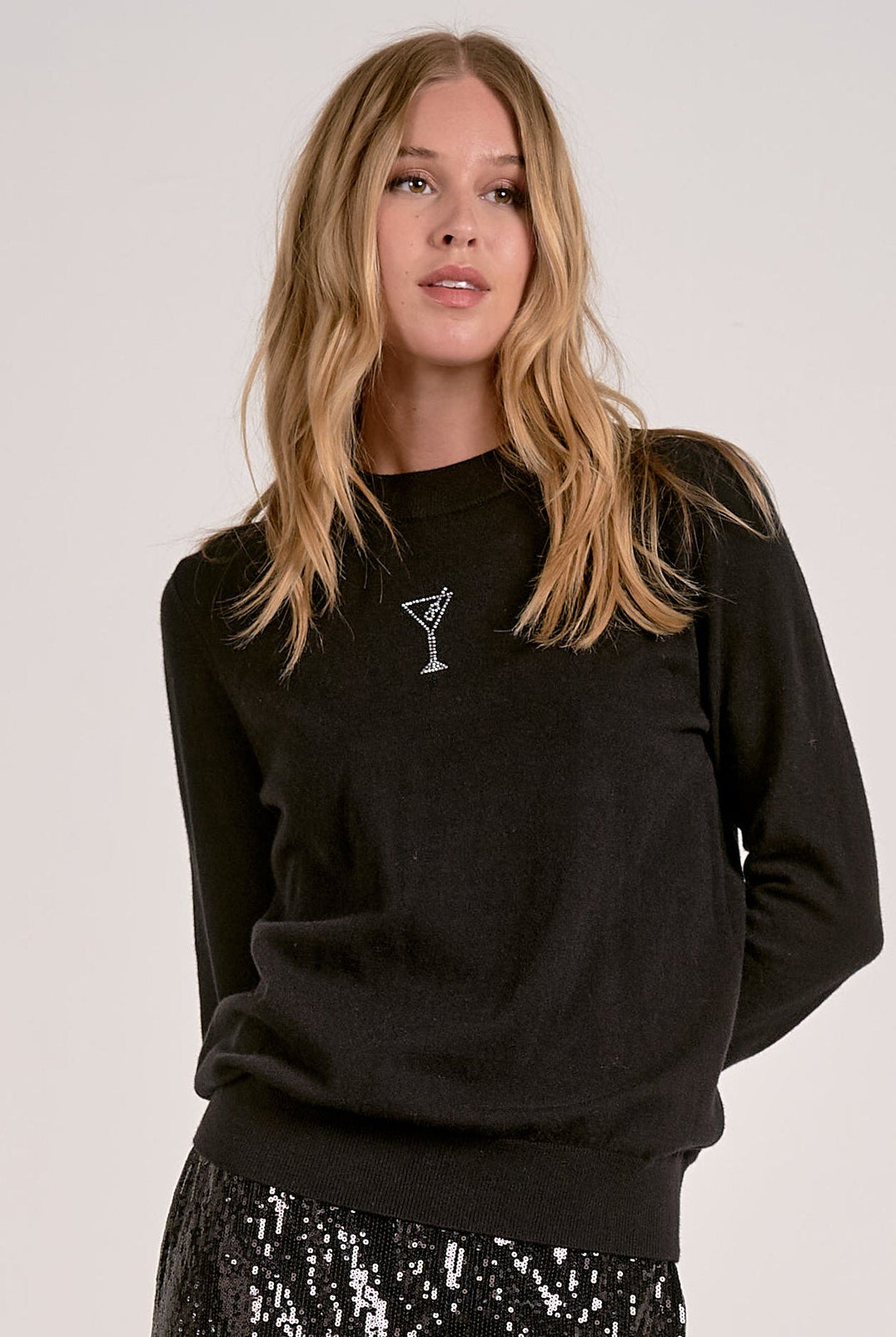 Model wearing black Martini Crewneck Sweater with rhinestone martini glass detail from Mainstream Boutique Bloomington
