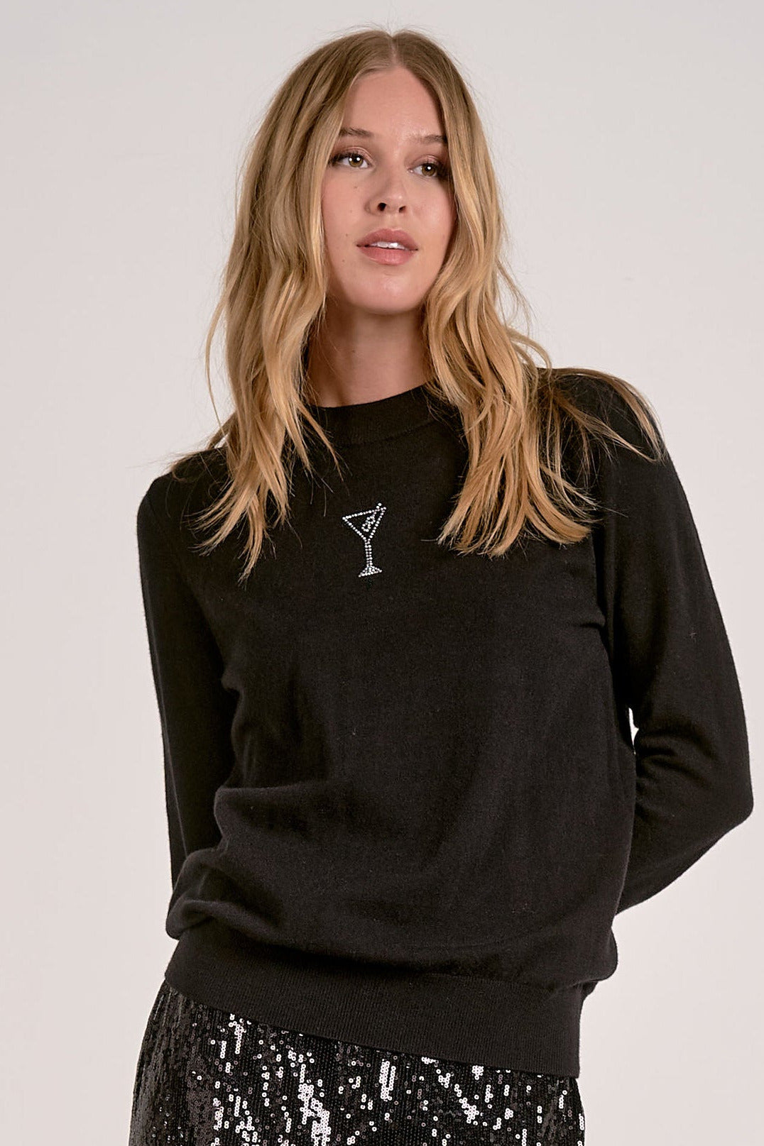 Model wearing black Martini Crewneck Sweater with rhinestone martini glass detail from Mainstream Boutique Bloomington
