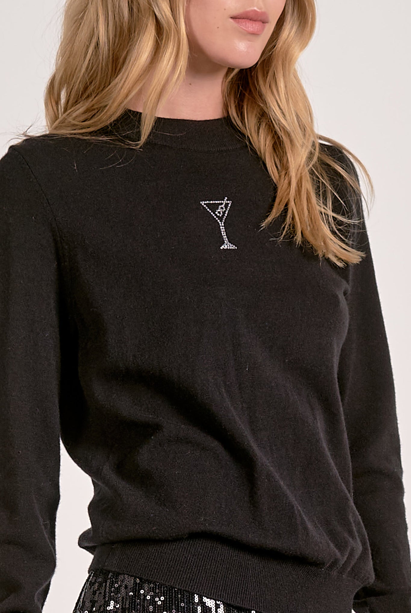 Model wearing black Martini Crewneck Sweater with rhinestone martini glass detail from Mainstream Boutique Bloomington