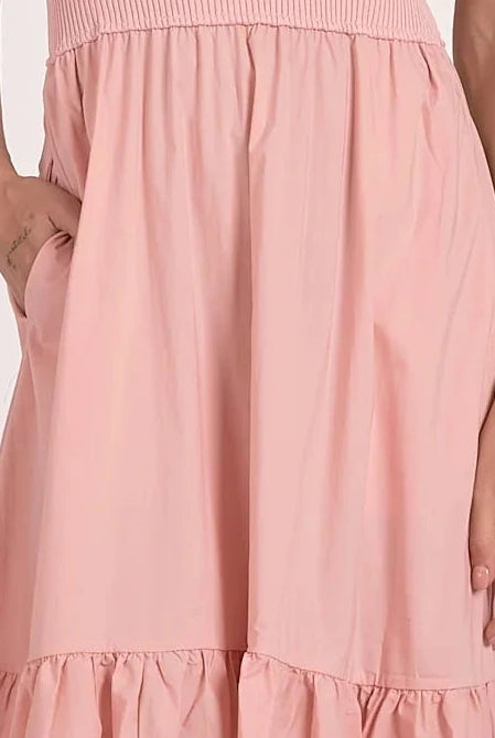 close up view of color and fabric on bottom of blush ribbed knit mixed media midi dress with tiered skirt and pockets