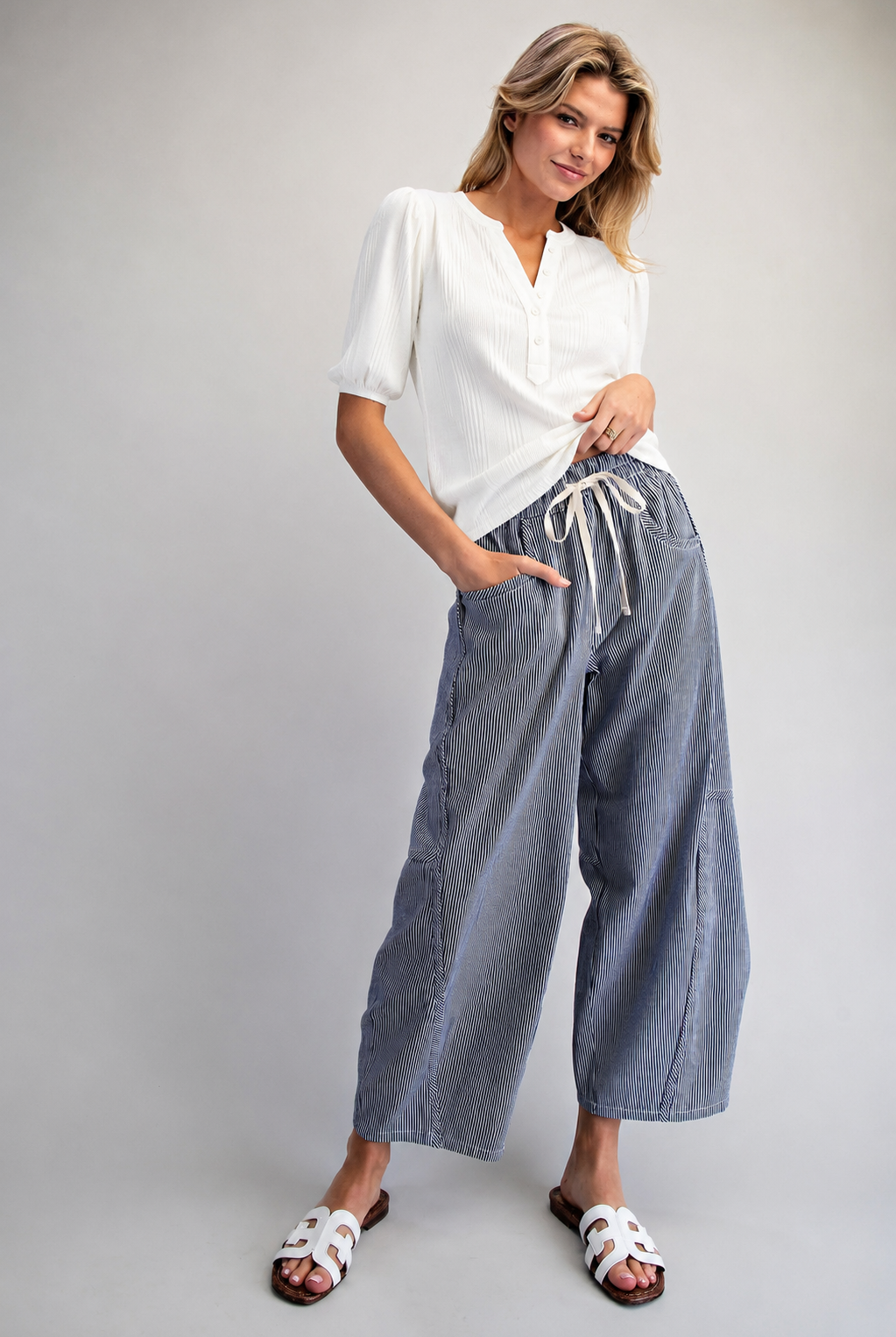 model with navy striped relaxed fit pants and mac and me elbow sleeve ribbed top in white