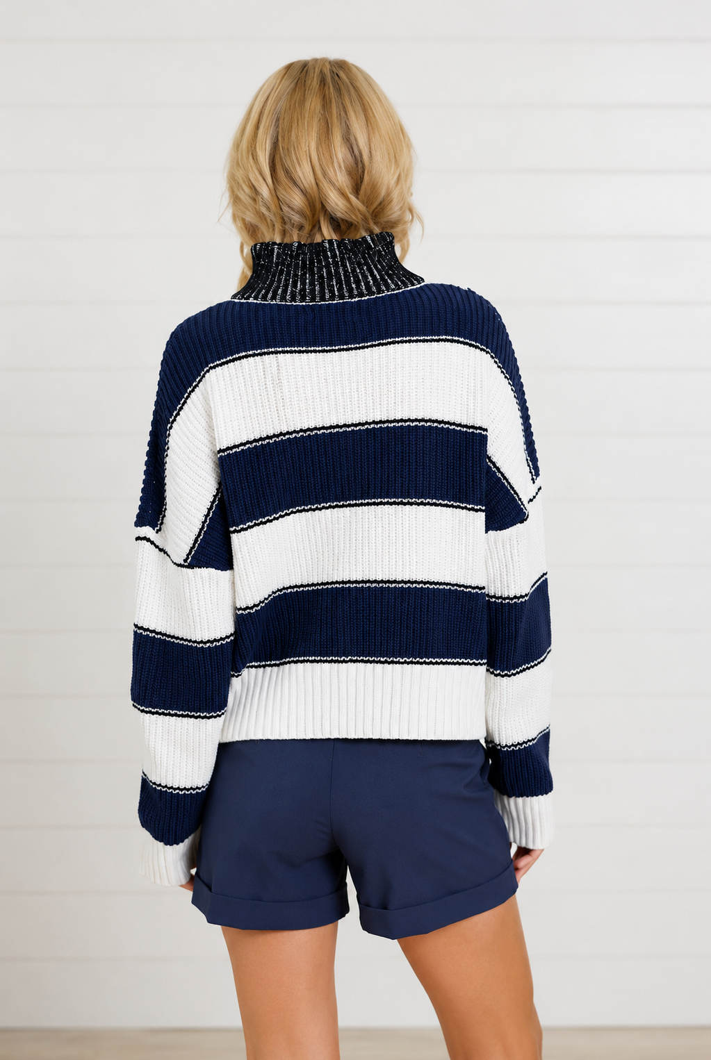 woman showing the back of navy and white stripe sweater